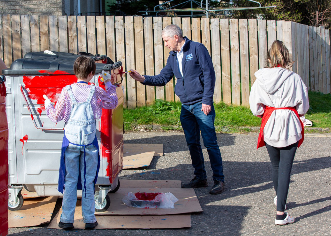 David Suttie, trustee of the Denis Law Legacy Trust, painting alongside local young people, sharing skills, stories, and pride of place.