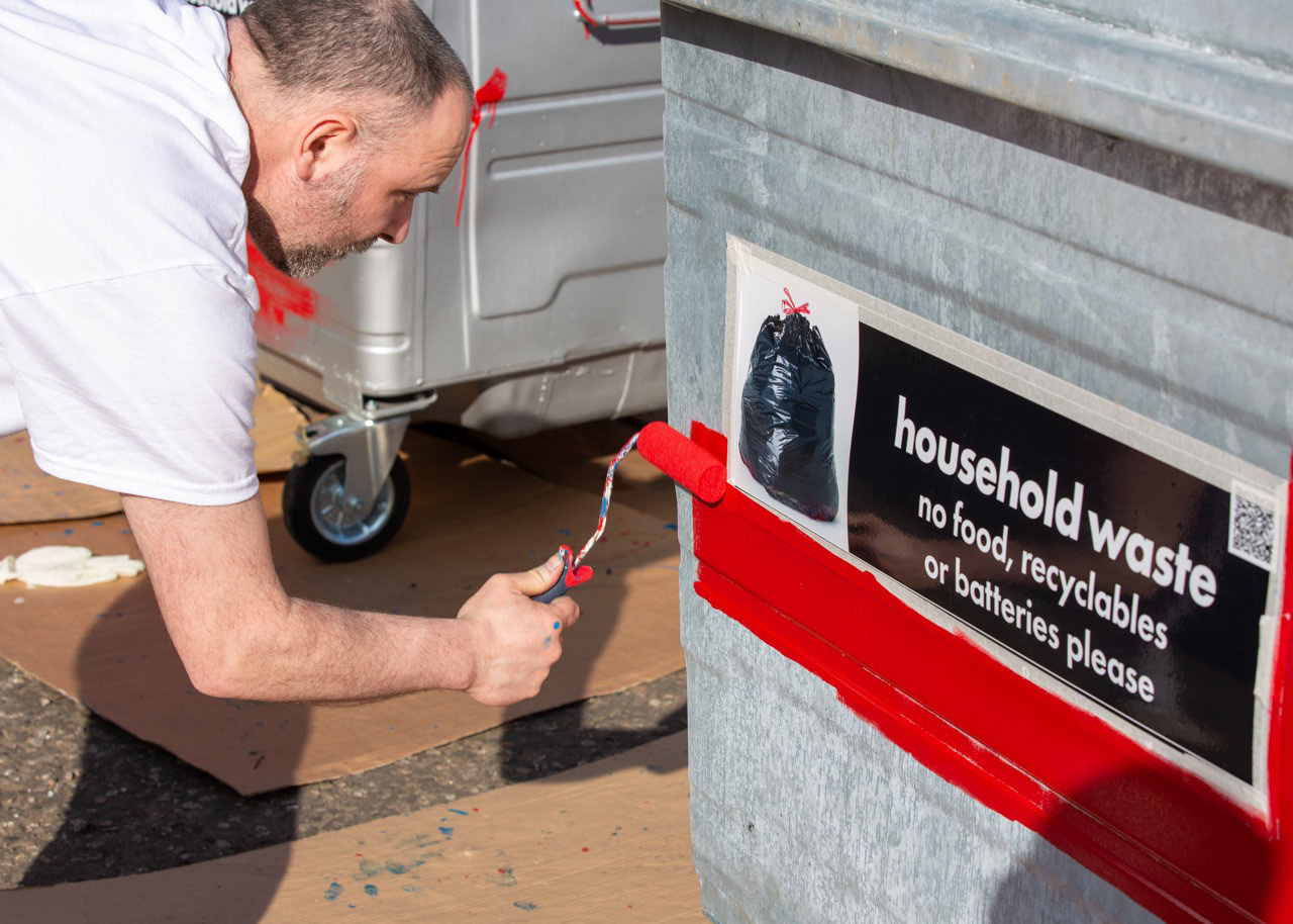 Local resident Dave working on the Manchester United–themed bins as part of the Printfield community project