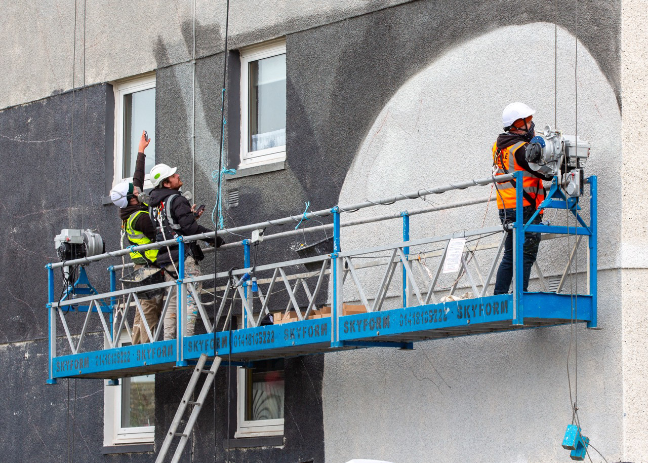 Stage Three: Jerome Davenport (second left) from Blank Walls arrives to begin the huge task of applying the murals