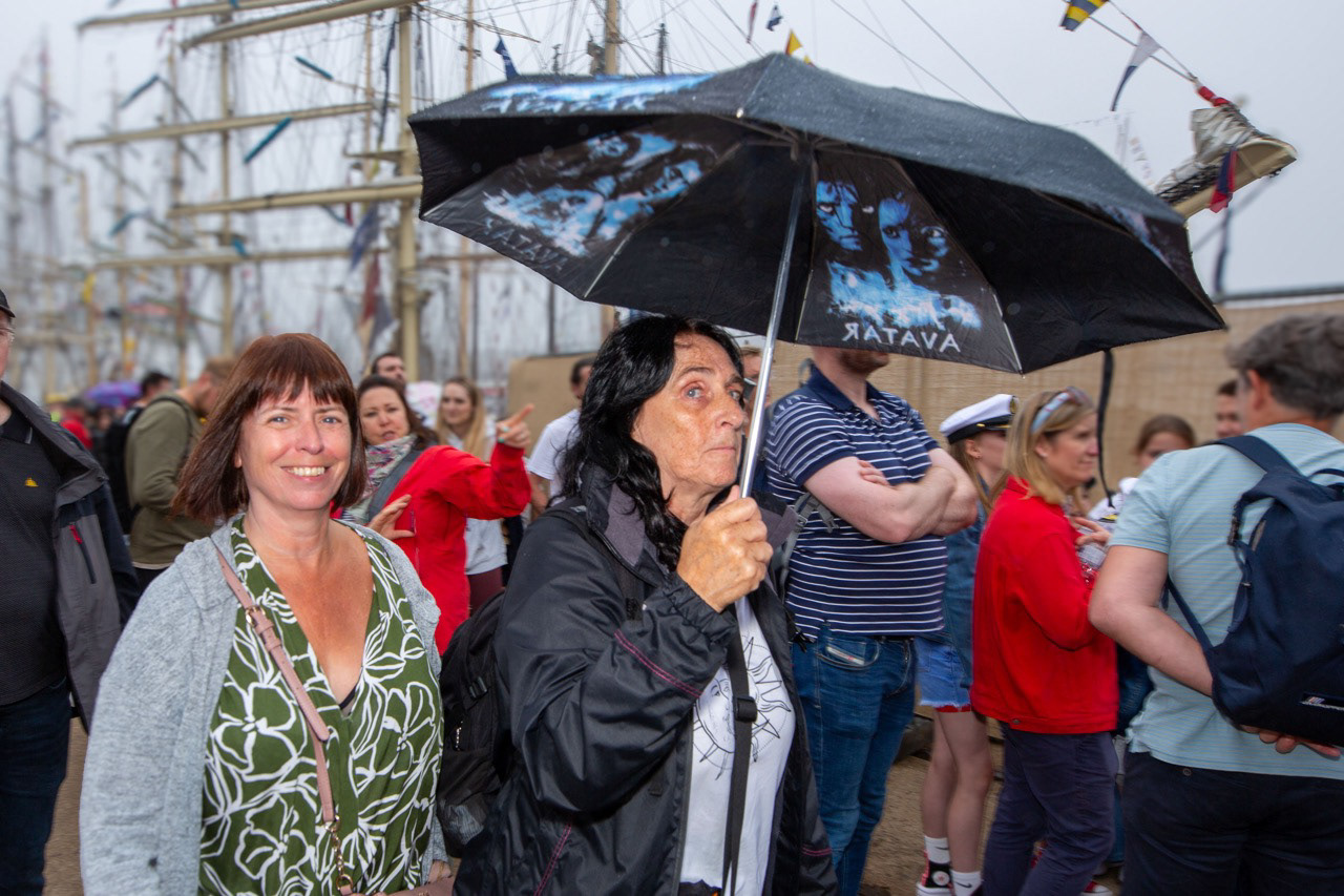 Smiles between showers, summer rain can’t dampen this mood