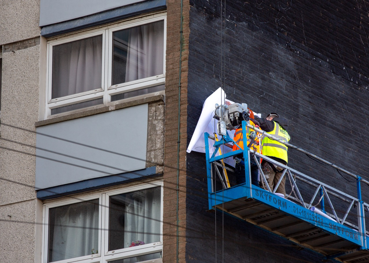 Stage Two: Alex and Andy work in close-up, applying the pouncing technique—an age-old method used to transfer designs from paper to surface. This same technique was employed by Leonardo da Vinci and other Renaissance artists during the preparation of frescoes in the Sistine Chapel, connecting the mural process to a long lineage of artistic practice.
