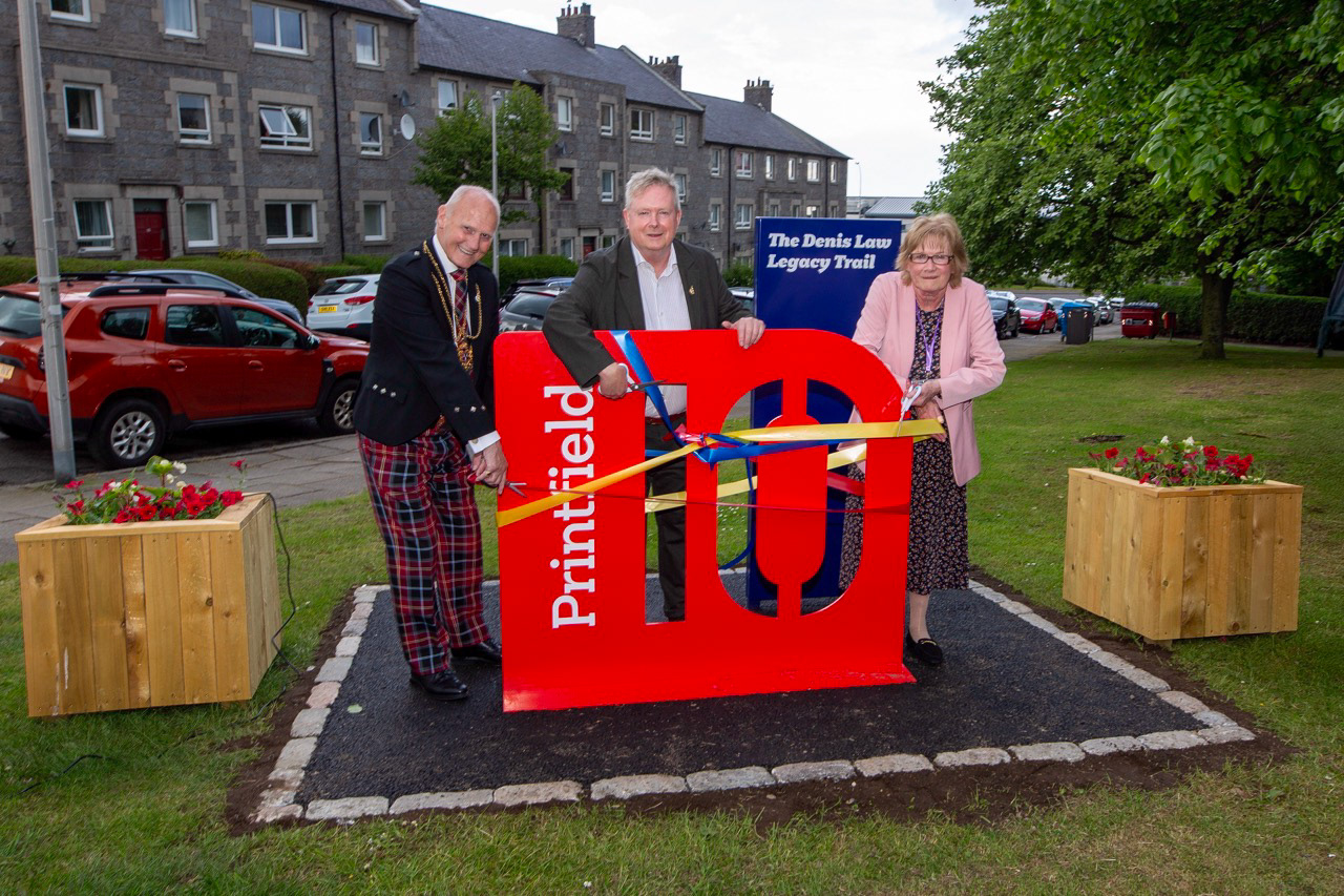 Cutting the ribbon: Aberdeen Lord Provost Dr David Cameron, Gary Law, and Printfield Community Coordinator Kit Trail mark the opening moment together.