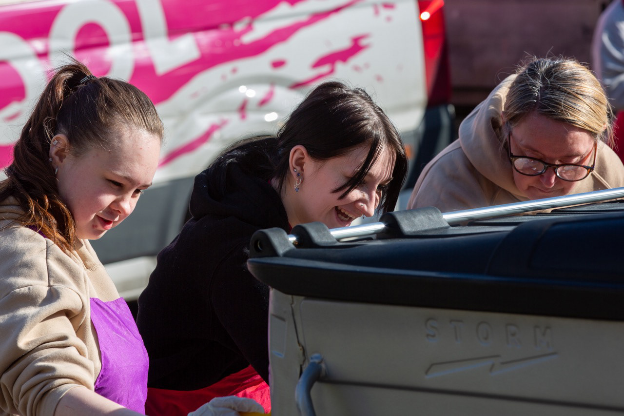 Printfield residents adding colour to the neighbourhood — painting bins together with smiles and pride.