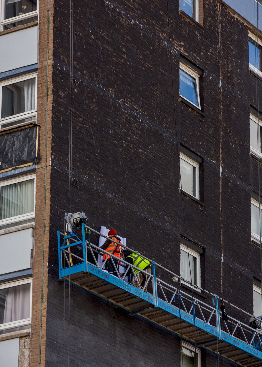 Stage Two Alex and Andy on the wall cradel begining the mural stenciling 