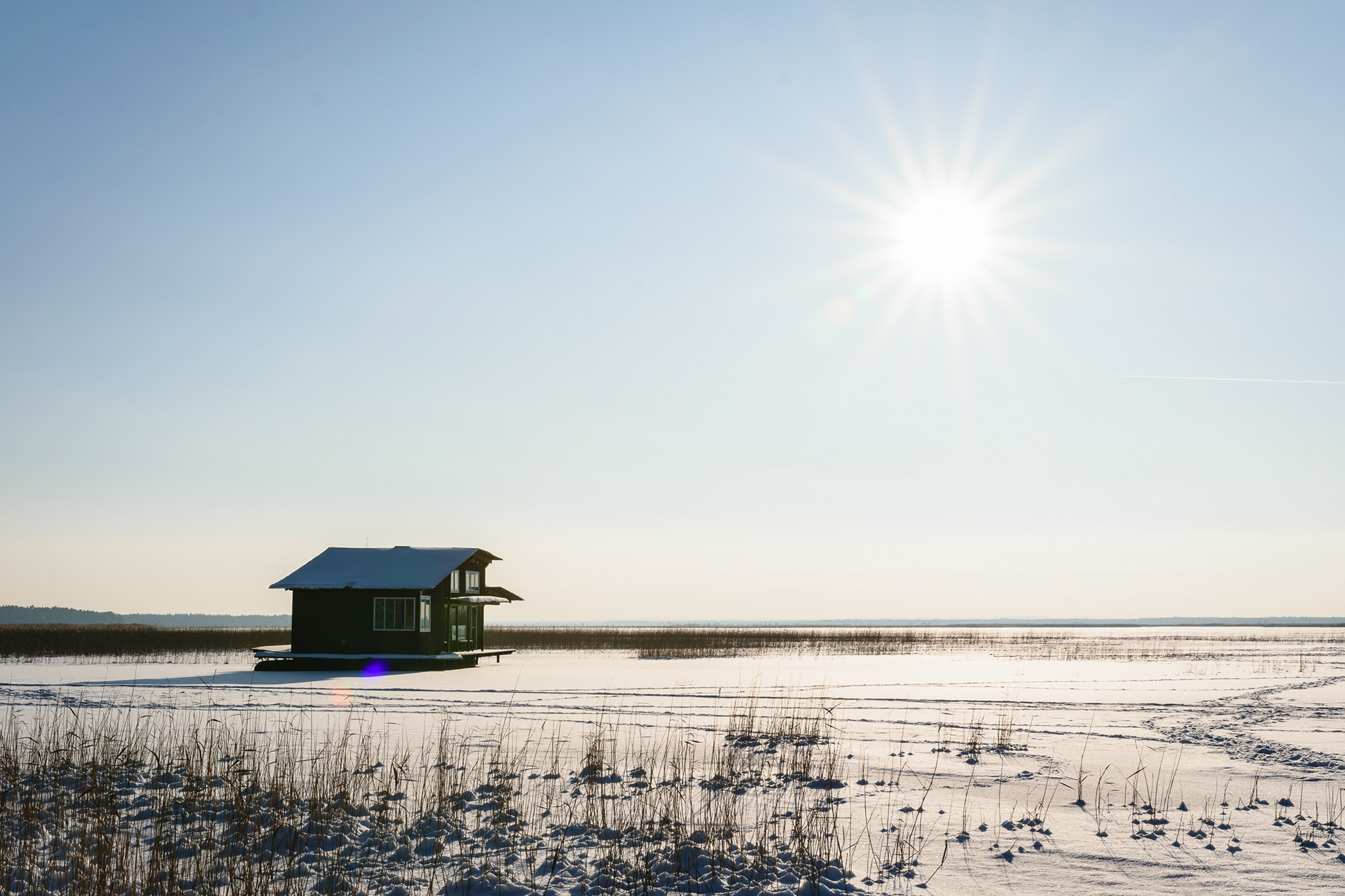 Frozen lake with floating house photo