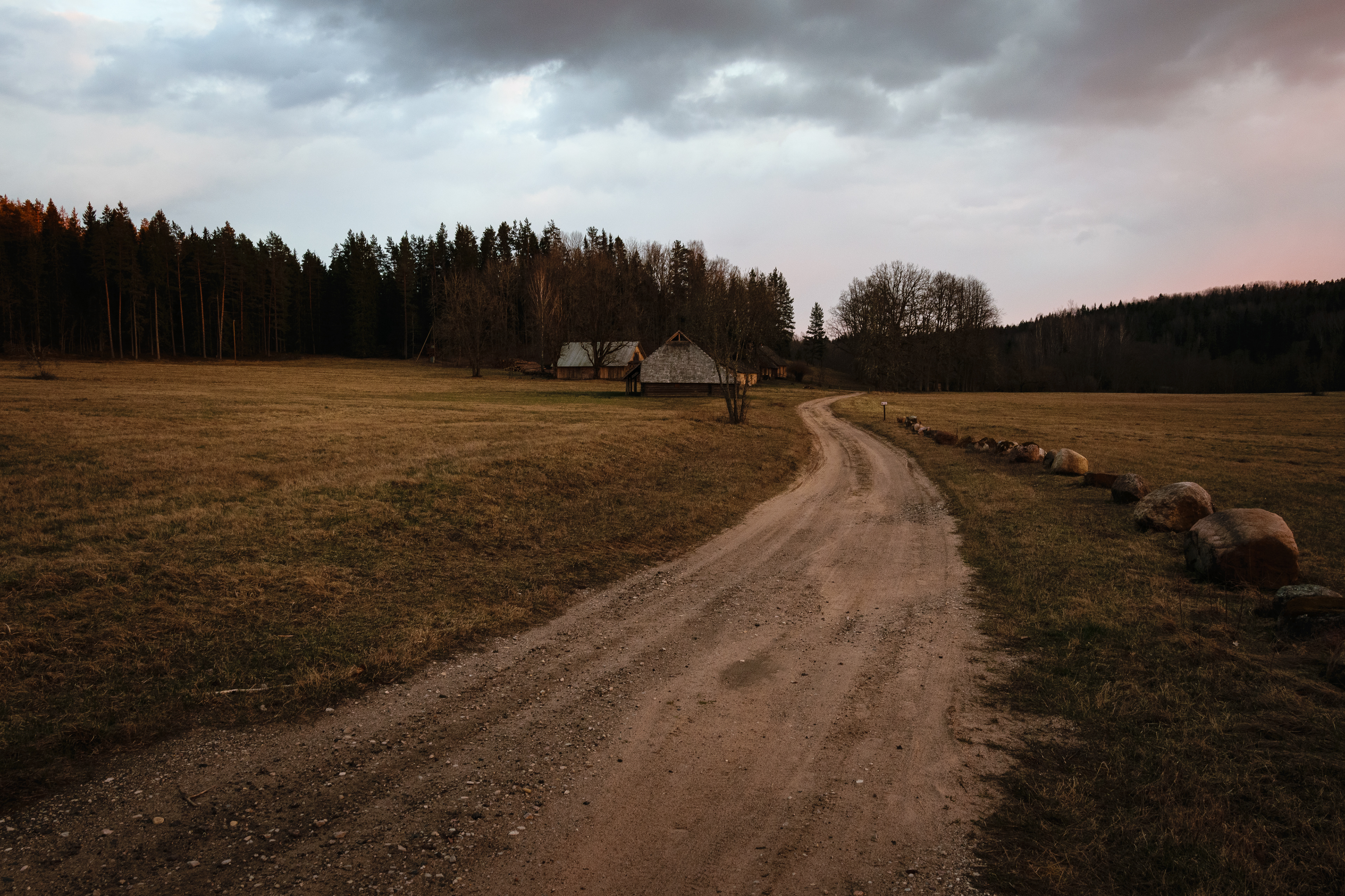 Countryside road leading to rural home in Latvia