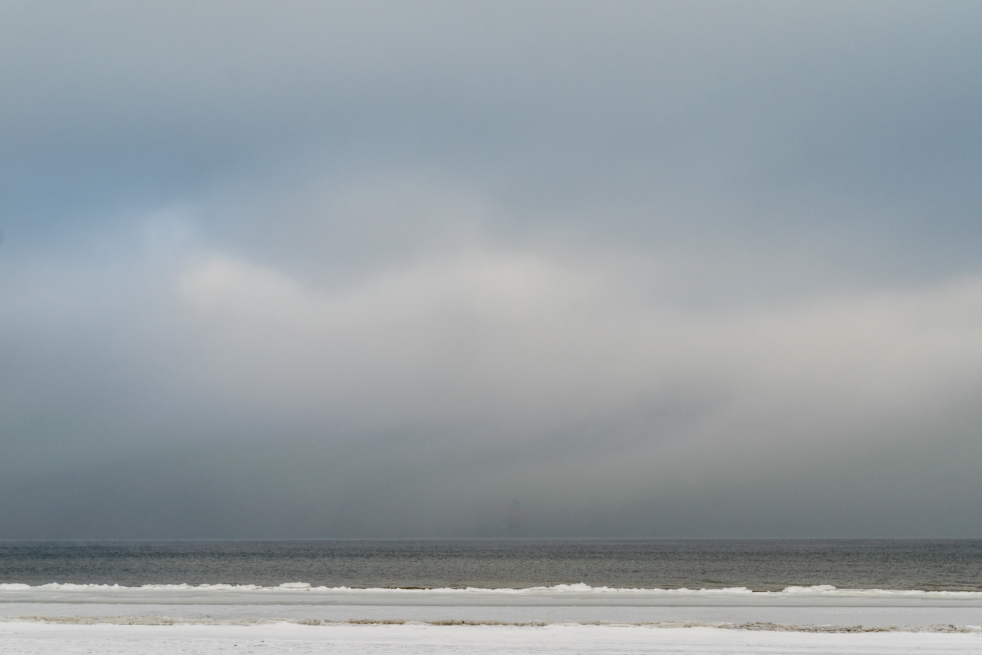 Partly frozen sea on a cloudy winter day