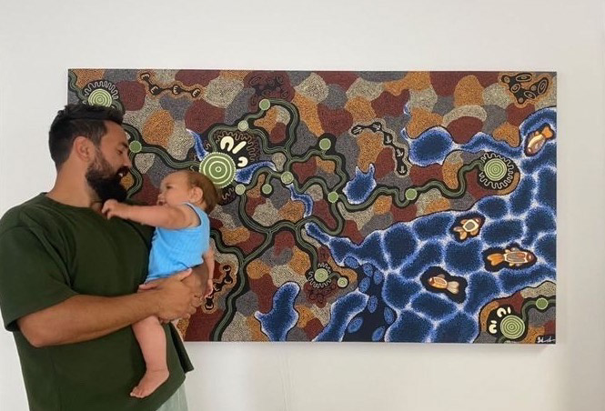 Matt and Remi in front of the painting. Remi likes to feel the dots.
