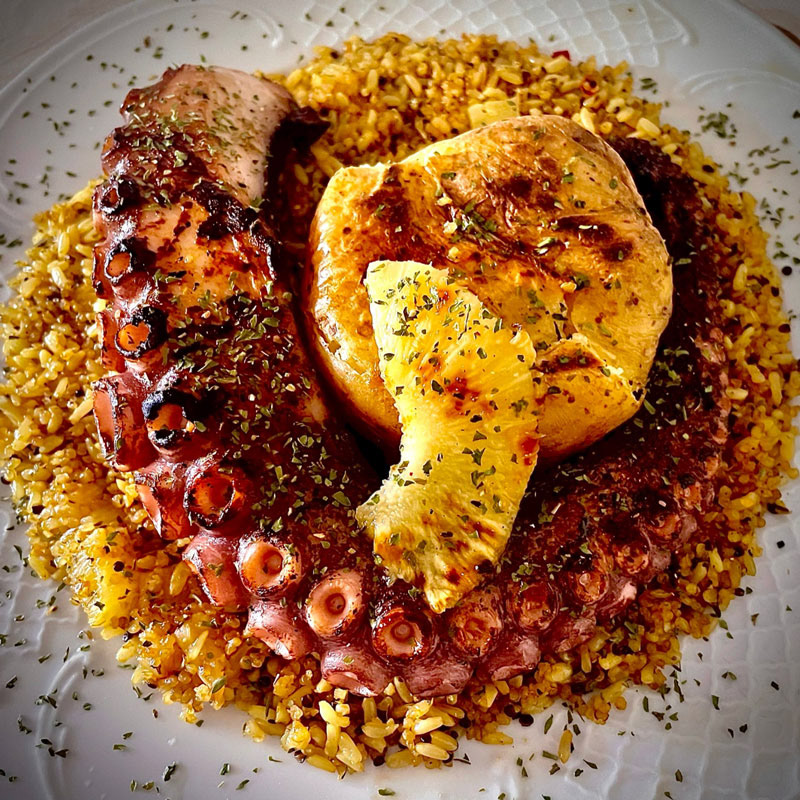 Roasted octopus with grilled potatoe, pineapple sauce and spicy quinoa