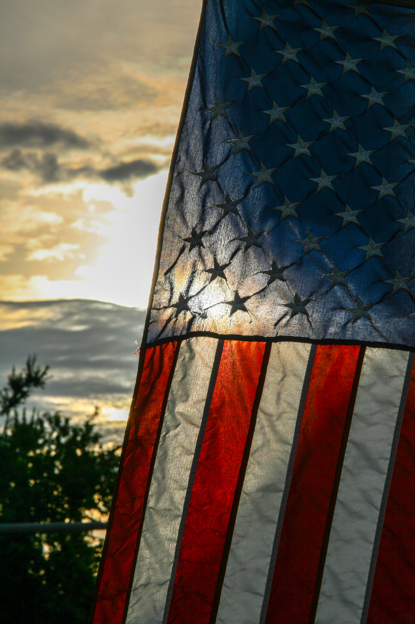 The American flag hangs infront of a midwest sunset.