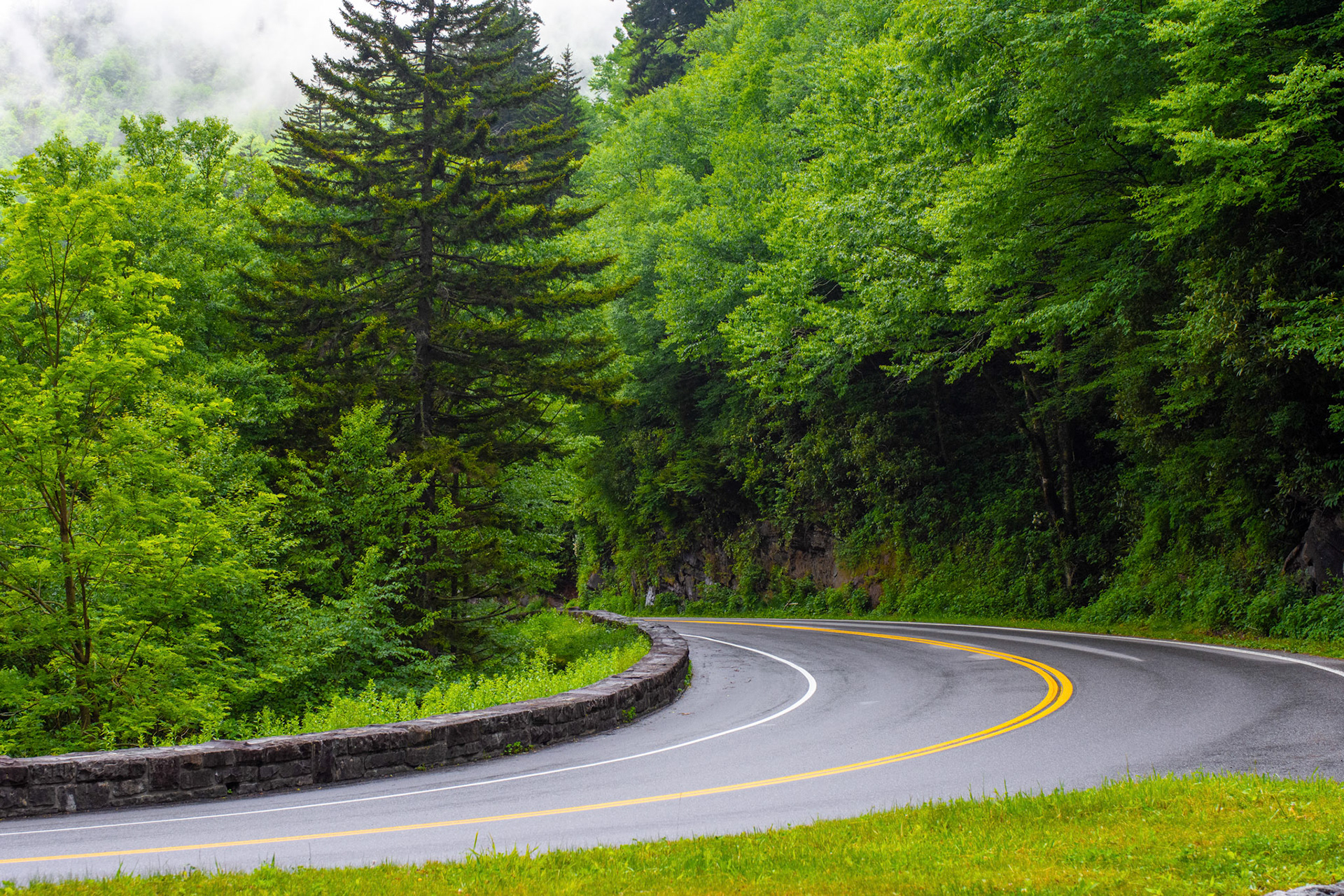 A winding road leads down a mountain pass in the Smoky Mountains