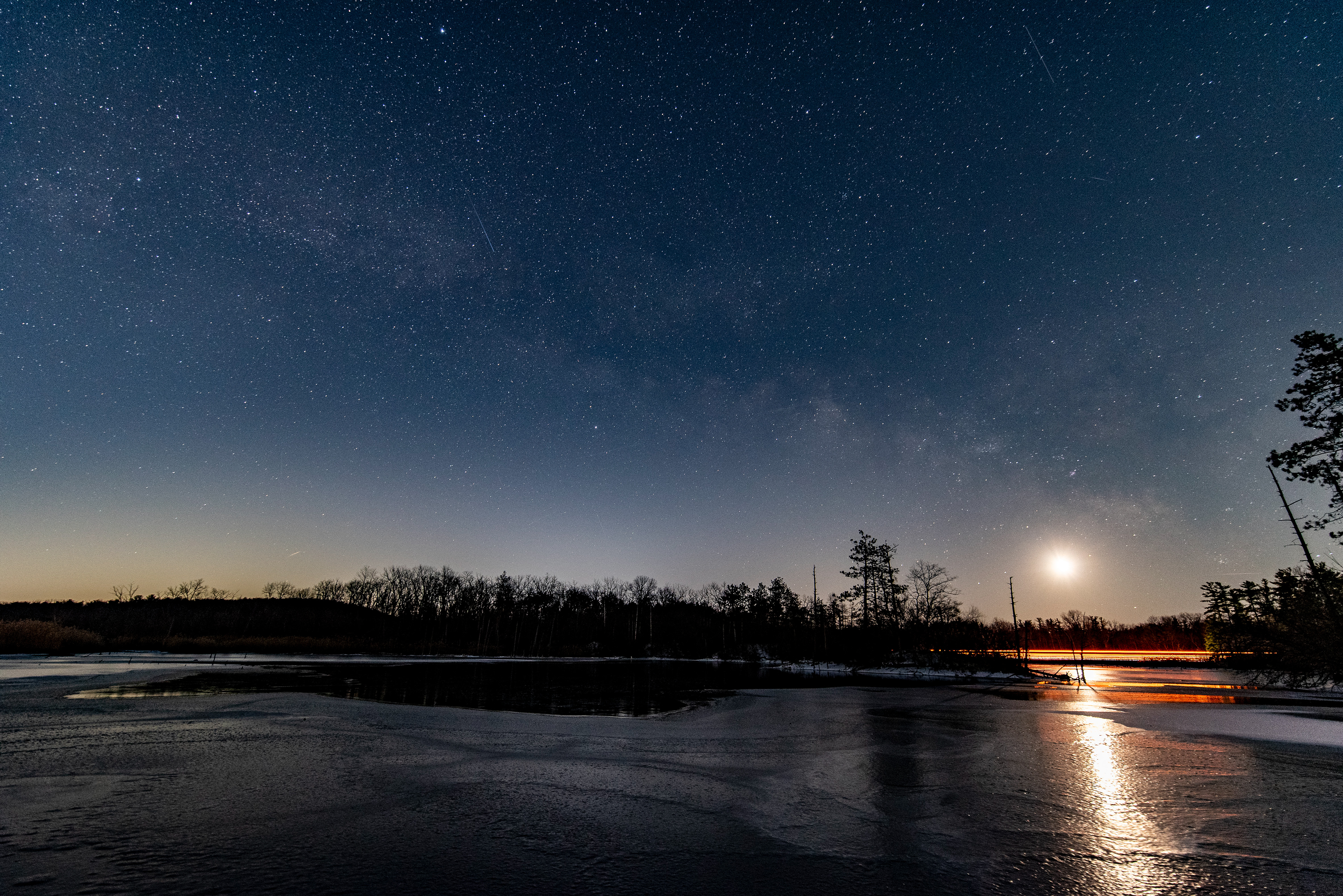 Milky Way a moon over a frozen lake