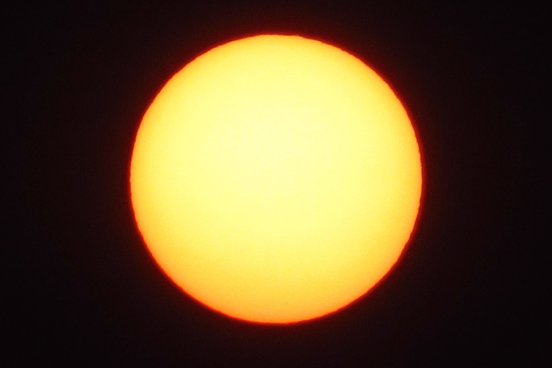 Setting Sun captured thru smoke-filled sky