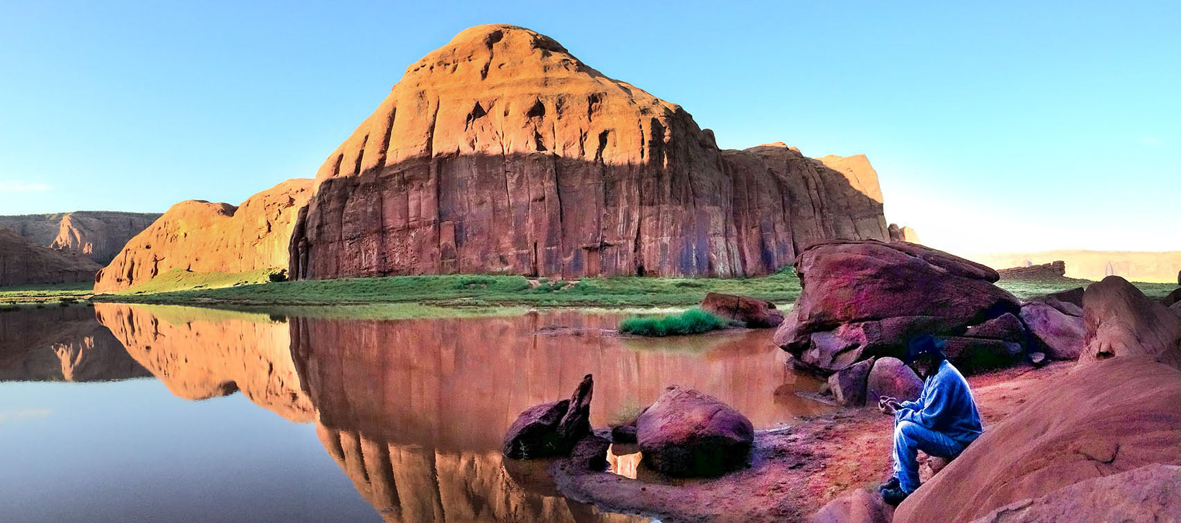 A Navajo guide photographs a shallow lake created by several days of rain. (Monument Valley, AZ)