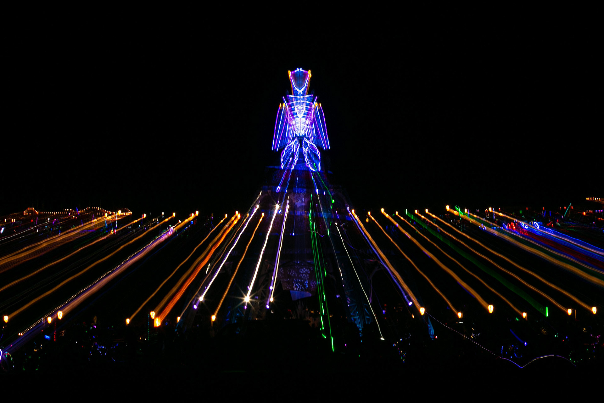 A zoom time exposure of The Man lit up at night.
