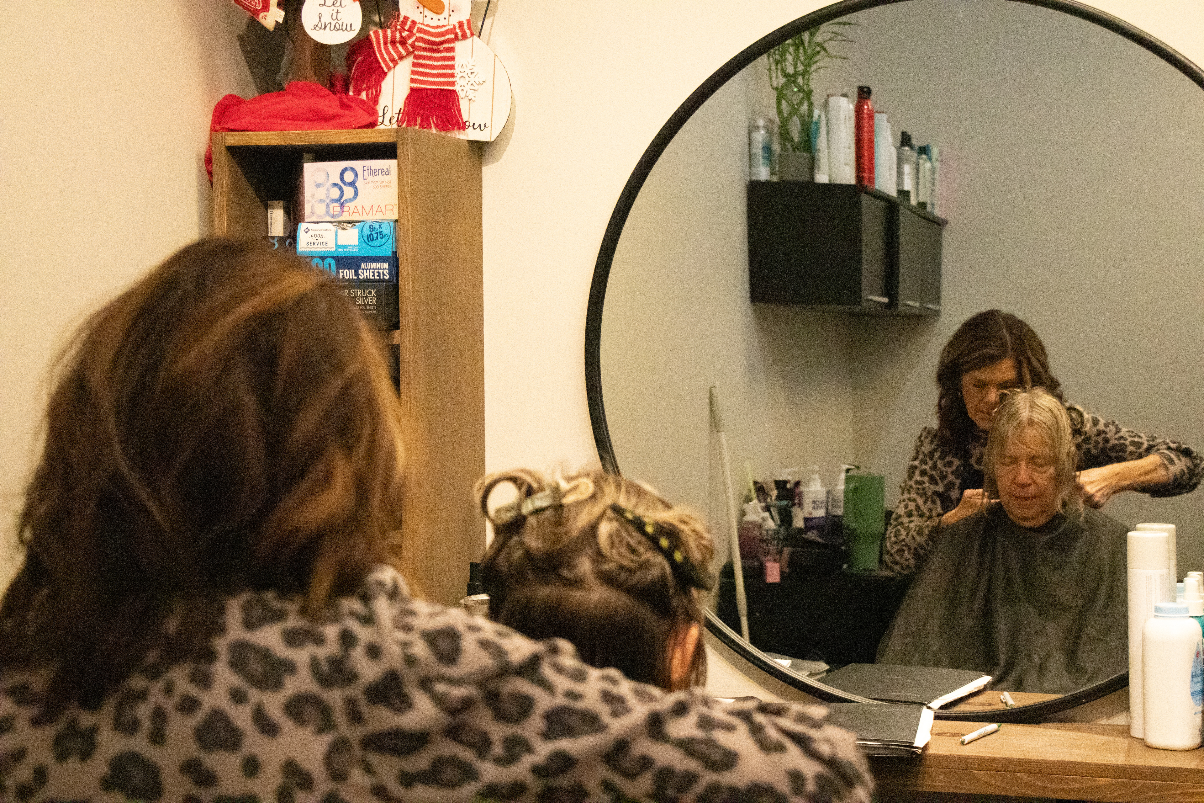 Angie Saladino with her client Sharen Lyons at her new, smaller, Hair Salon, Simplicity Salon after moving to a smaller studio space after having issues with her landlord and been on a waiting list for over a year. In Davenport, IA on Wednesday Dec. 4, 2024. (SJMC/ Sierra Christensen)