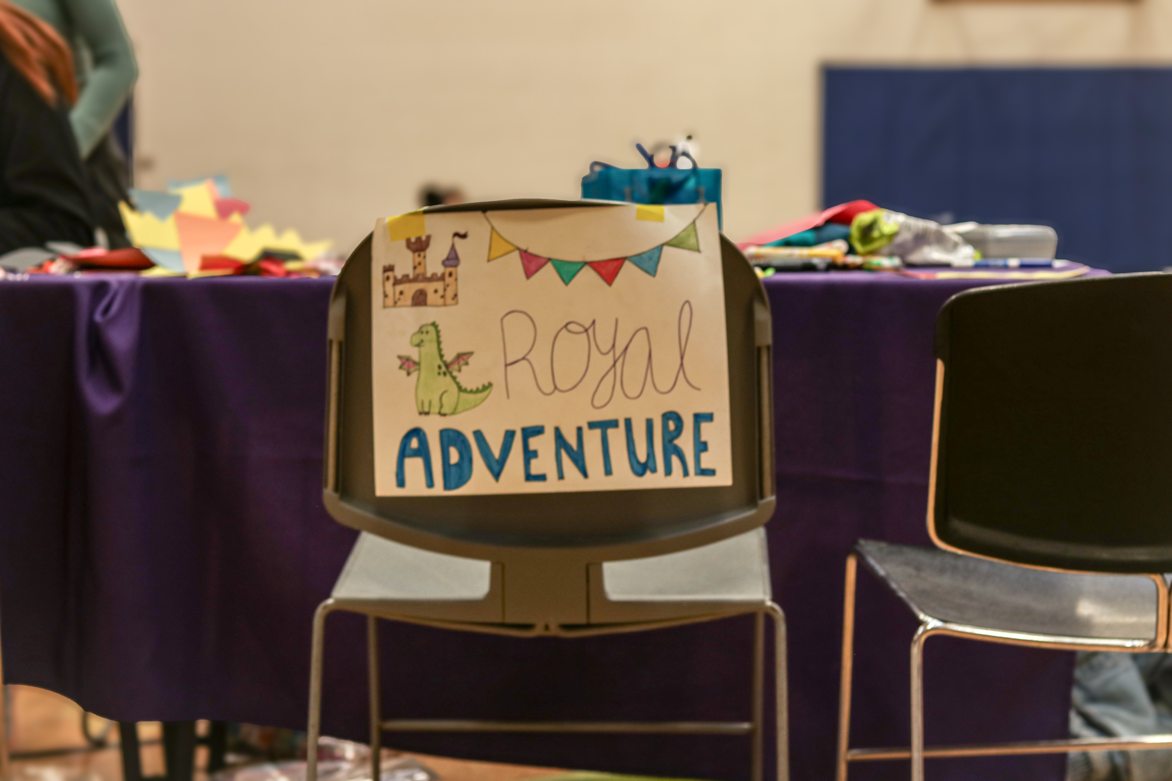A craft table at the UI Day of Play event hosted by Iowa City Parks and Recreation and the University of Iowa Therapeutic Recreation Department held at the Mercer Aquatic Center in Iowa City, IA on Saturday, Nov. 16, 2024.This craft table offered activities like paper crown making and scooter board racing involving pool noodles and a dragon stuffed animal. (SJMC/ Sierra Christensen)