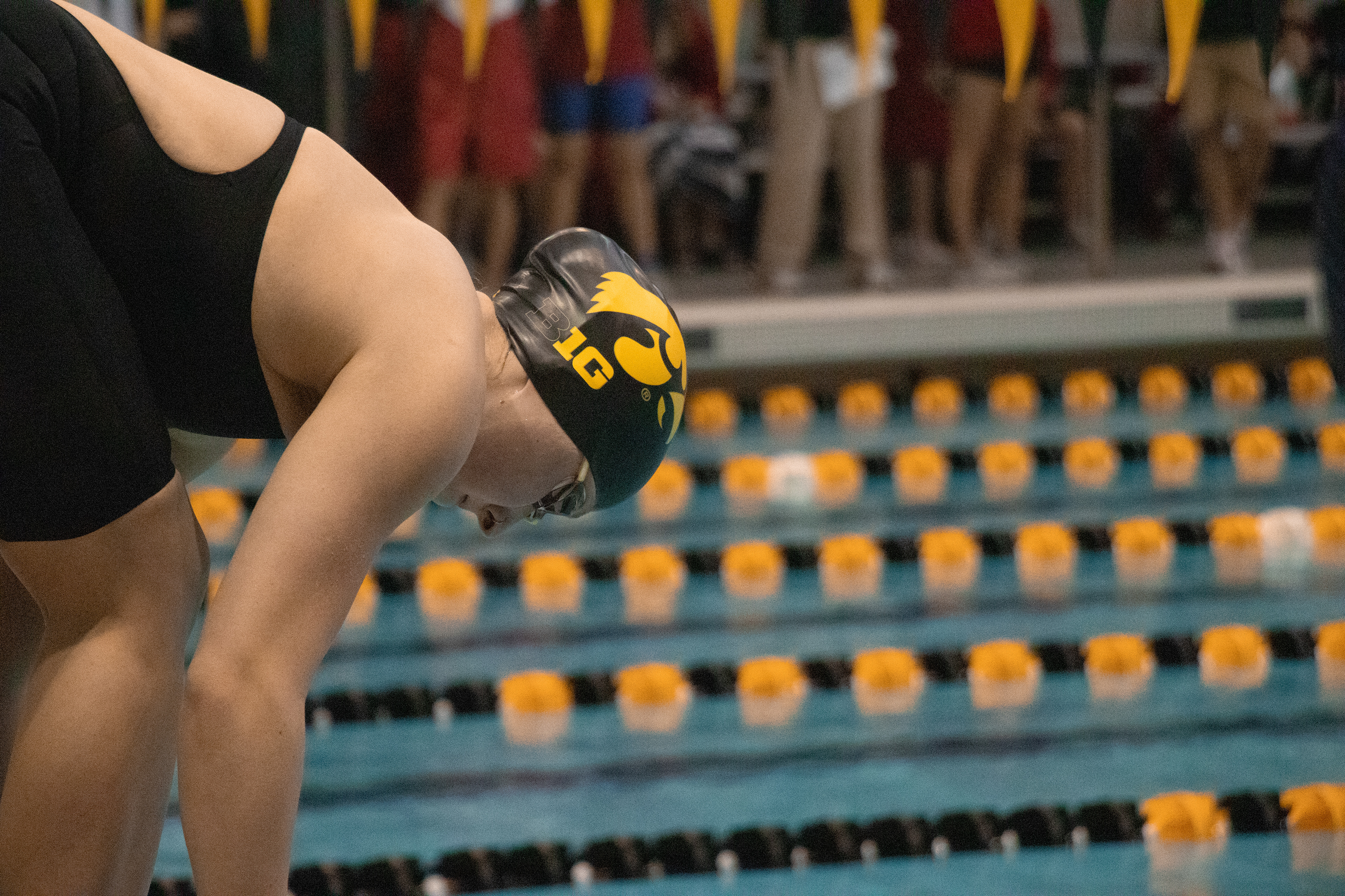 University of Iowa’s Madison Stone (left) prepares to dive in to swim the 200-meter Freestyle preliminary, at the Hawkeye Invitational Swim Meet at the Campus Recreation and Wellness Center Iowa City, IA on Nov. 22 2024. (SJMC/ Sierra Christensen)
