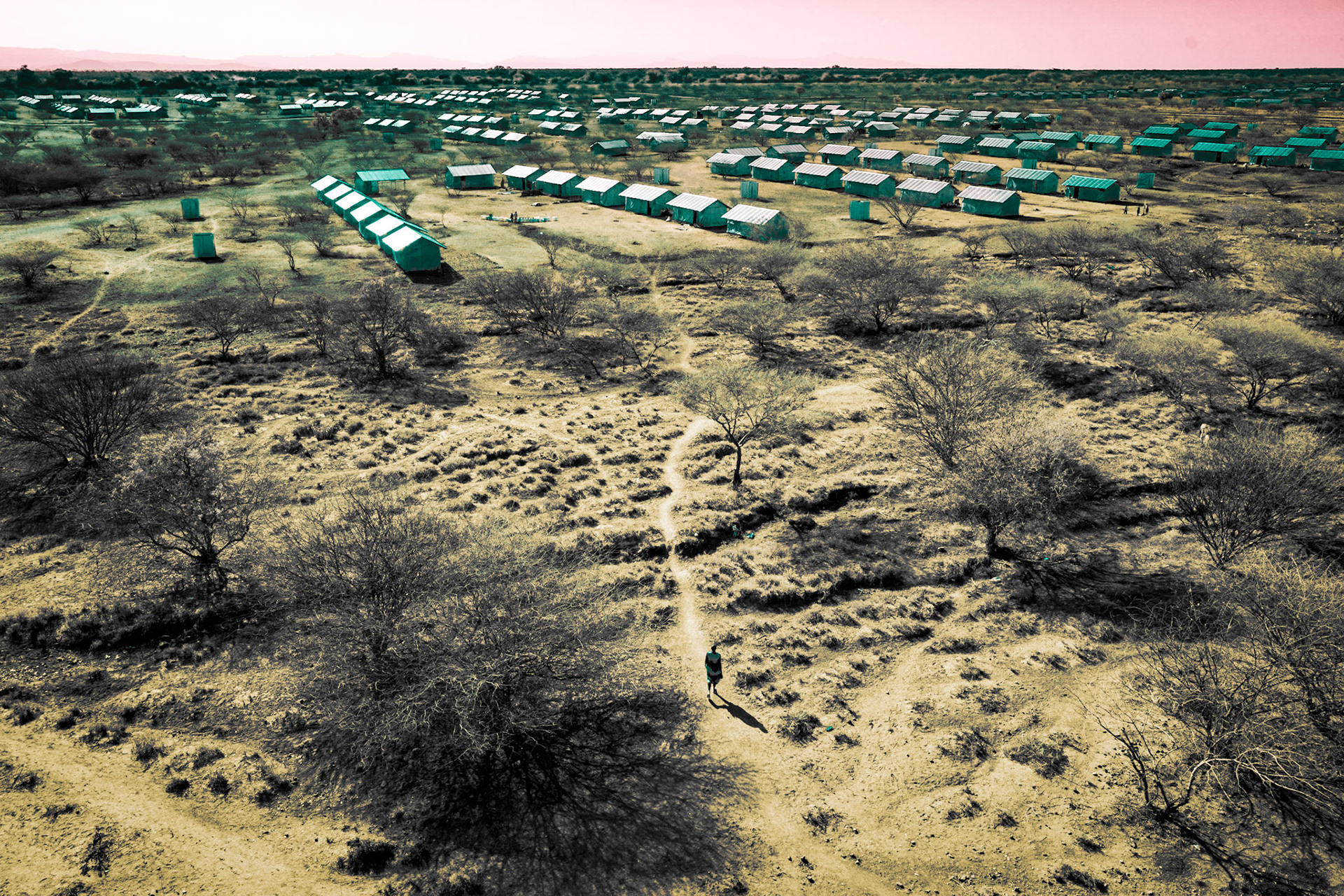 A South Sudanese refugee walks in the newly constructed Kalobeyei Settlement, built to accommodate the influx of refugees in Kenya. In September 2016, the number of South Sudanese refugees in neighboring countries exceeded one million, including over 185,000 who fled due to violence in Juba in July 2016. The settlement was constructed in response to the overflow of refugees in the Kakuma camp.