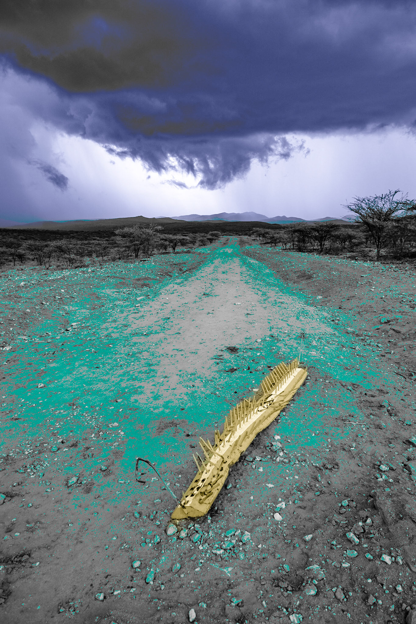The sky is overcast with dark clouds above a deserted roadblock on the Archer's post-Baragoi road in Suiyian. It had been eight months since Suiyian has seen any rain.