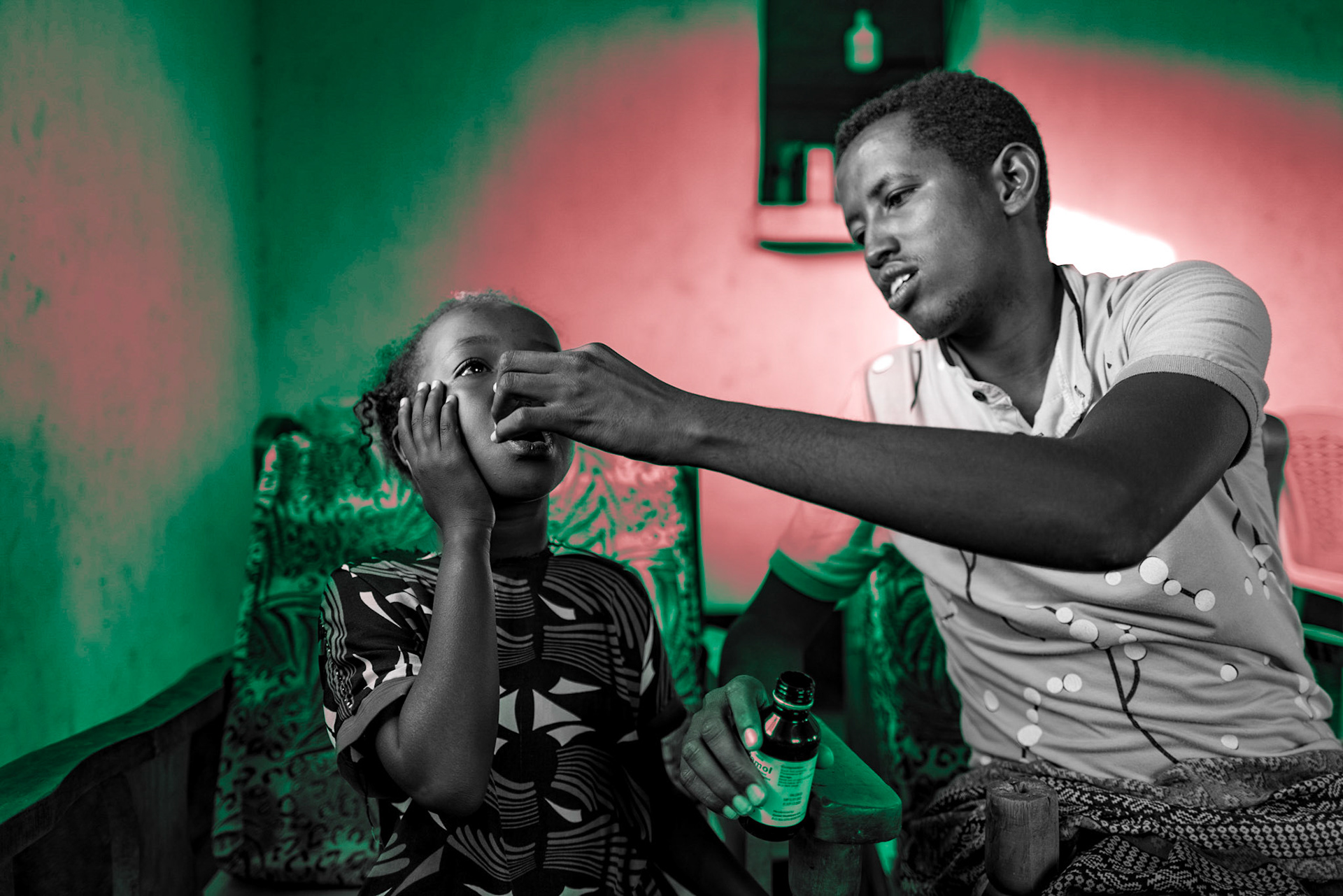 In Maikona, the young daughter of a local pastor is taking Amol syrup to treat her fever. The availability of medicine and medical facilities is limited in the remote village. The full extent of COVID-19's impact on the area is currently unknown.