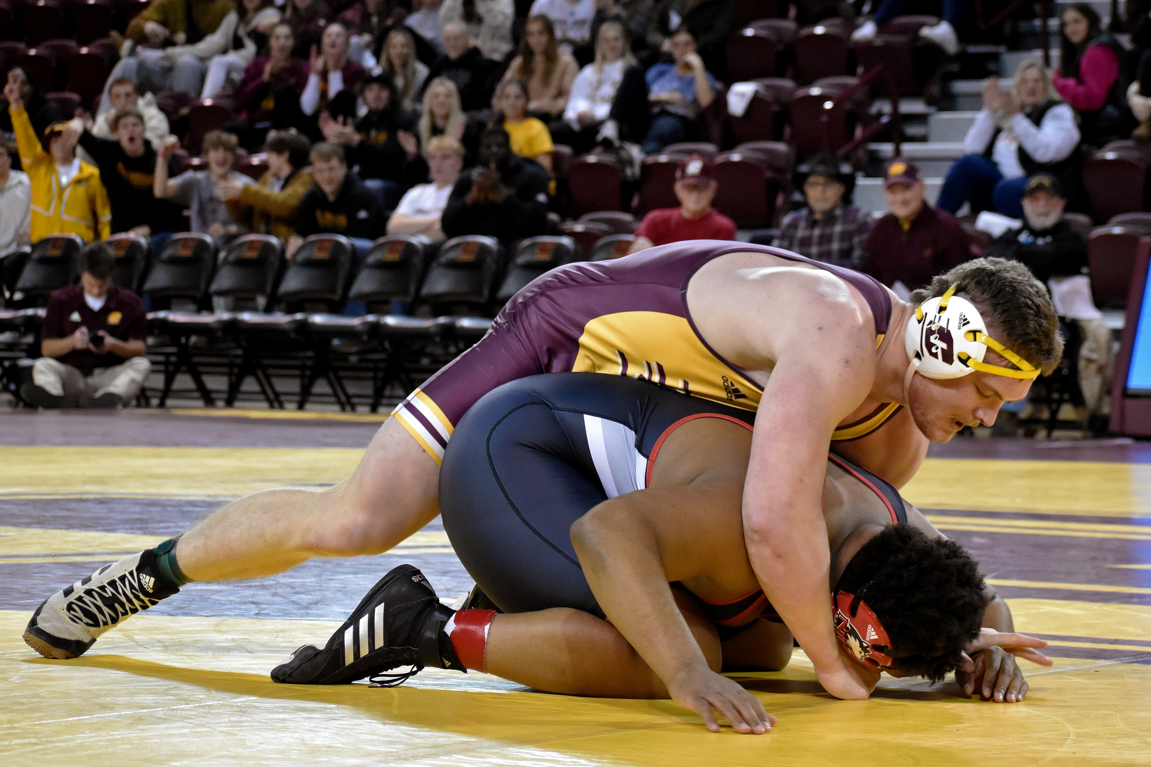 Port Bryon redshirt freshman Bryan Caves wrestles Terrese Aaron during a match against Northern Illinois University Friday, Jan. 13 in McGuirk Arena. Caves won, making him 15-8 for the season.