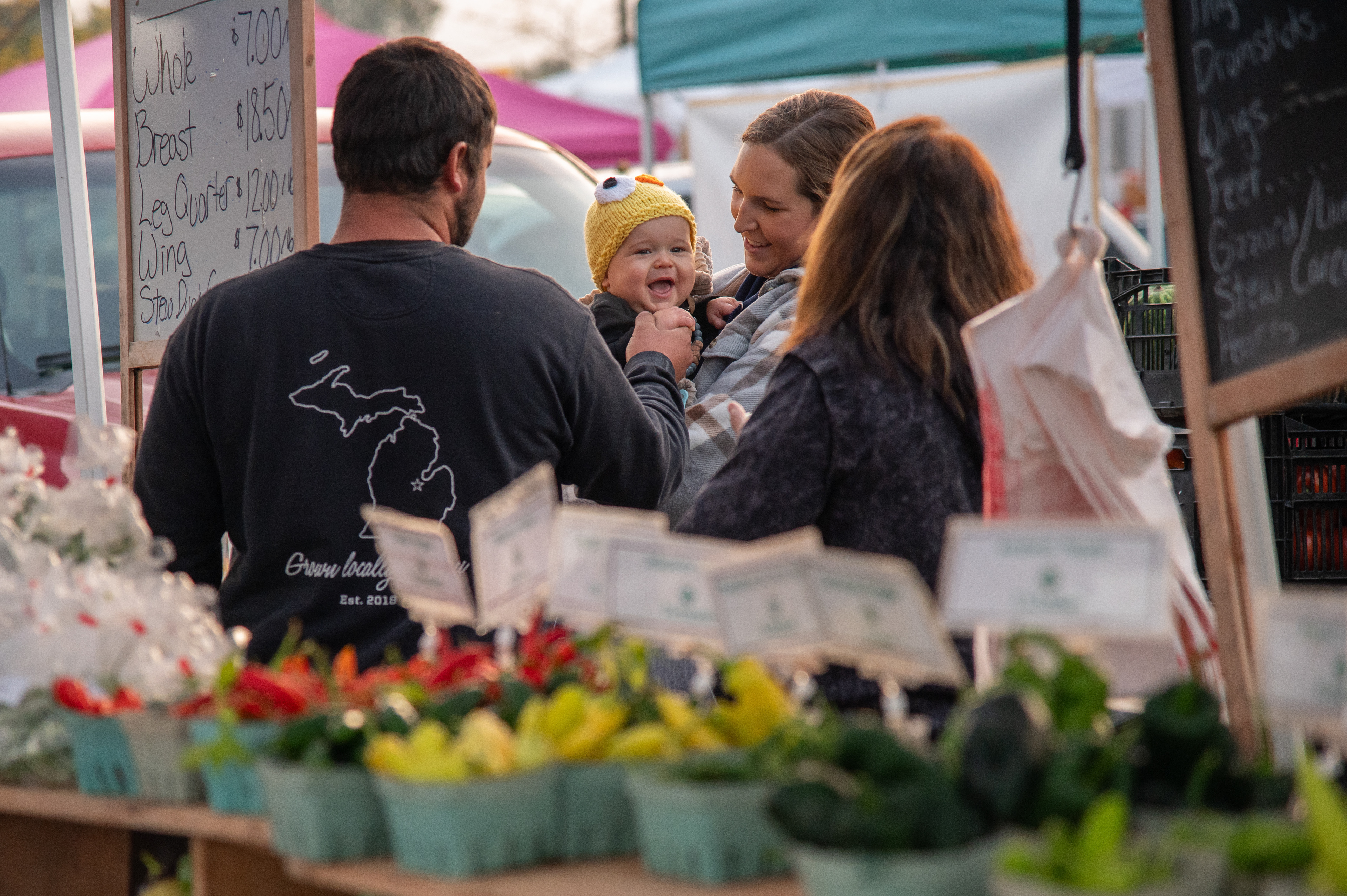 Tyler Shepherd holds his son Adam’s hand as his wife Hannah holds him at the Midland Farmer’s Market, 825 East Main Street, Midland, Michigan, Saturday, September 30, 2023. Tyler hopes to pass the farm down to his children.