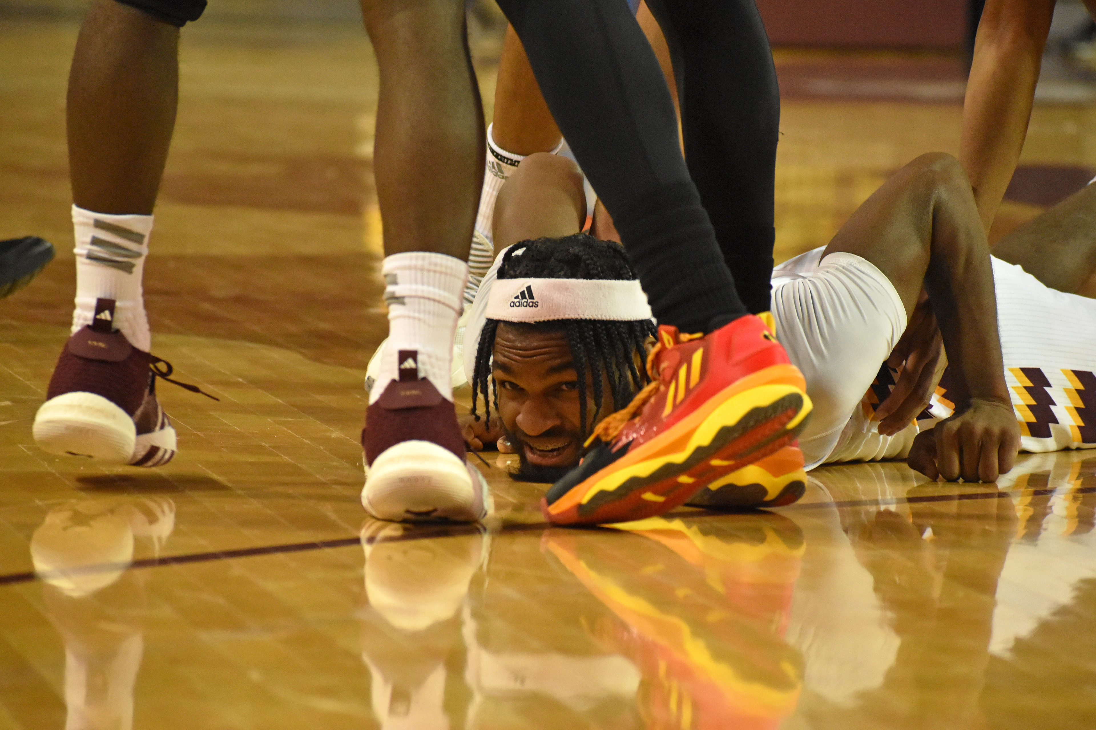 Freshman guard Reggie Bass lays on the floor after diving for a loose ball during a game against Northern Illinois Saturday, Feb. 25 in McGuirk Arena. Bass had six rebounds.