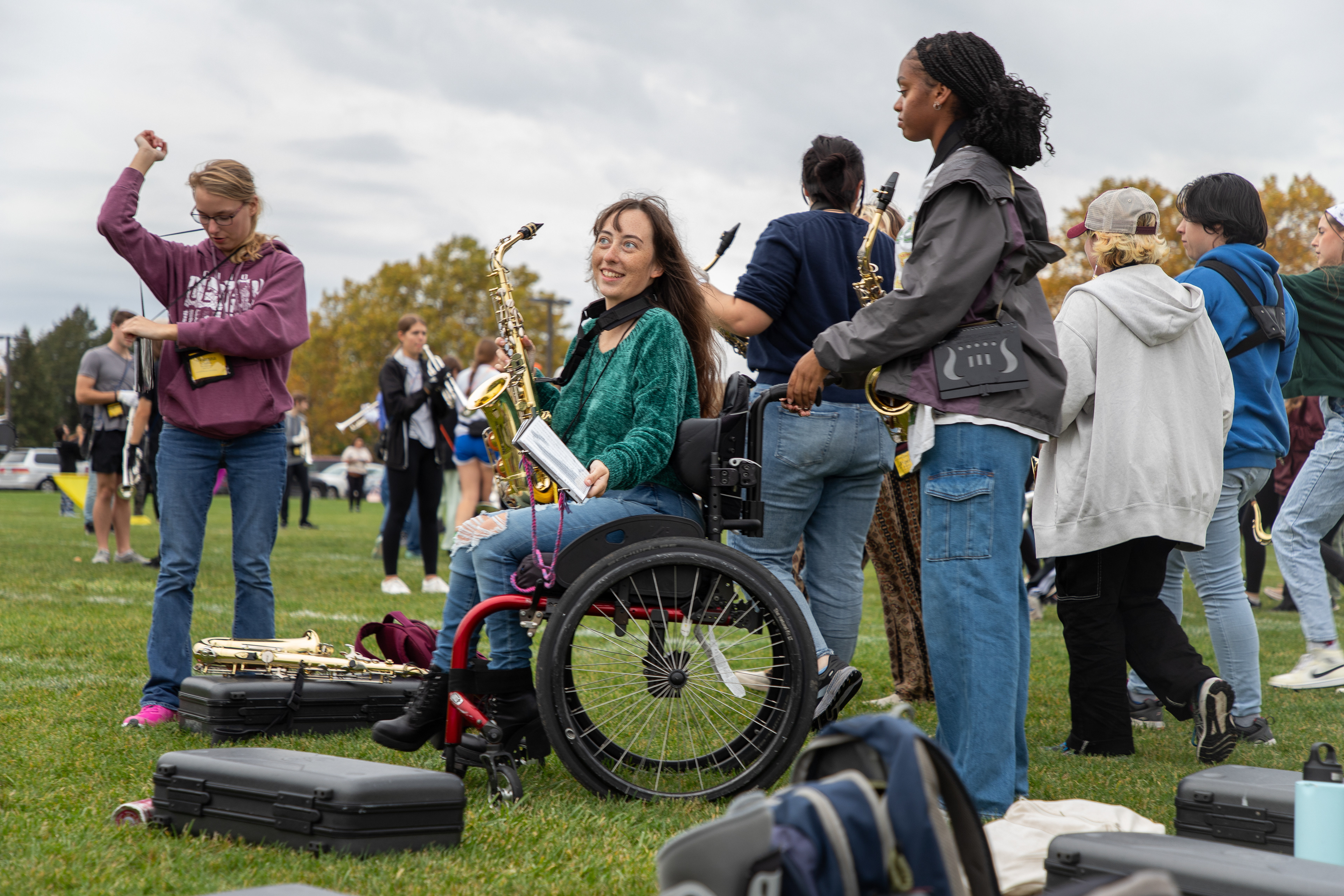 Ariah Bremby pushes Gaia onto the field as marching band rehearsals start at Jack Saunders Marching Band Field, on the campus of Central Michigan University, Mount Pleasant, Michigan, Thursday, October 26, 2023. Bremby also plays the alto saxophone.