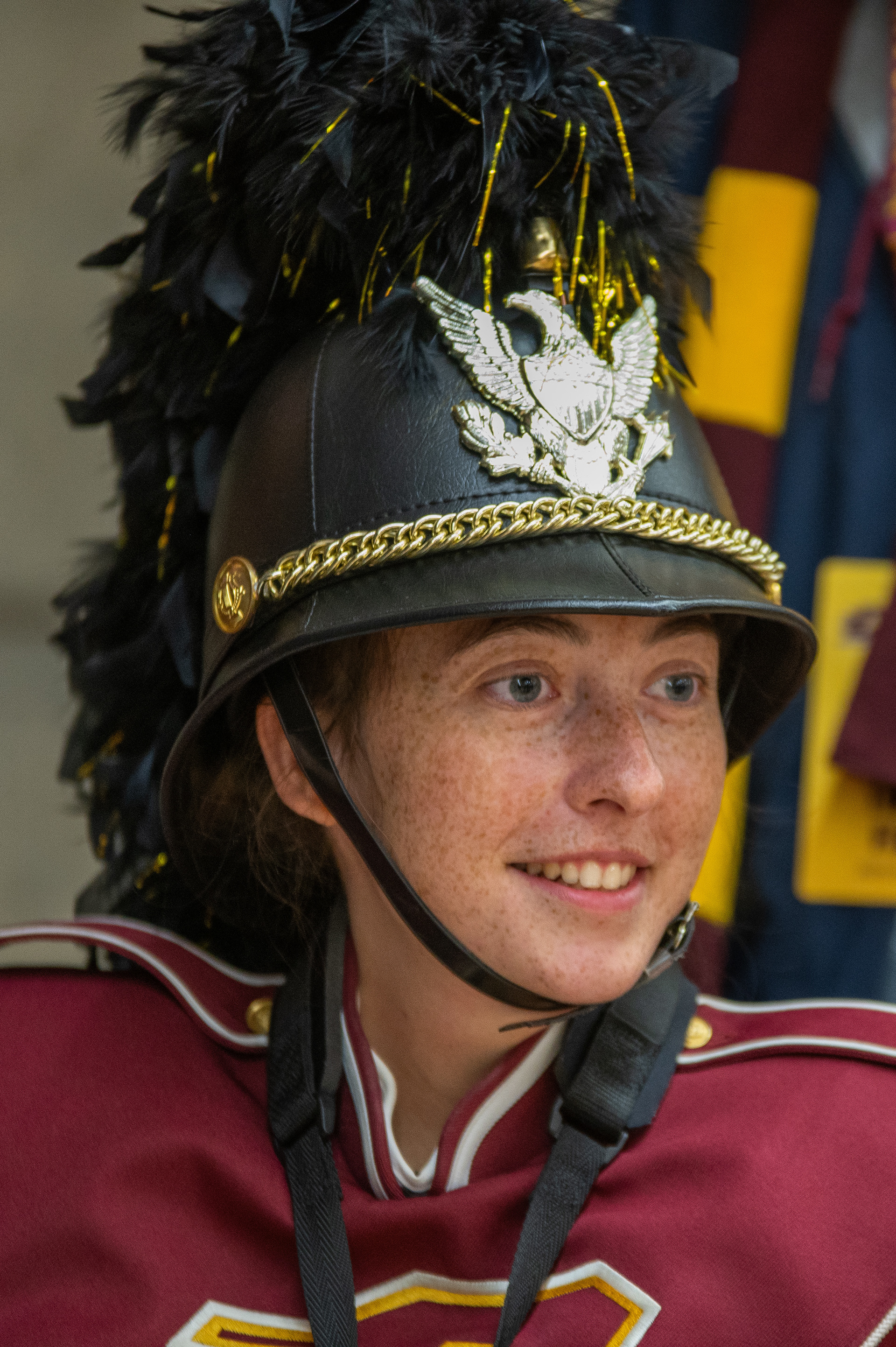 Gaia smiles in her uniform in the Student Activity Center, on the campus of Central Michigan University, Mount Pleasant, Michigan, Tuesday, October 31, 2023. Before the band heads out to the field, they line up by sections in the SAC. Here, Gaia lines up in the front with the drum majors, band director and color guard.