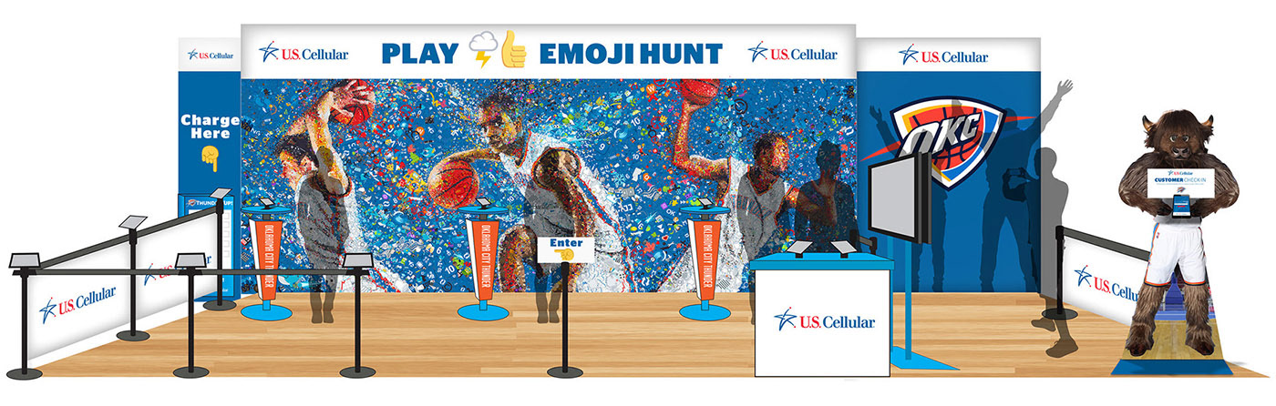A booth setup for the "Emoji Hunt" game at the Oklahoma City Thunder's Chesapeake Arena, featuring a colorful mosaic, branded elements from U.S. Cellular, and a mascot character.