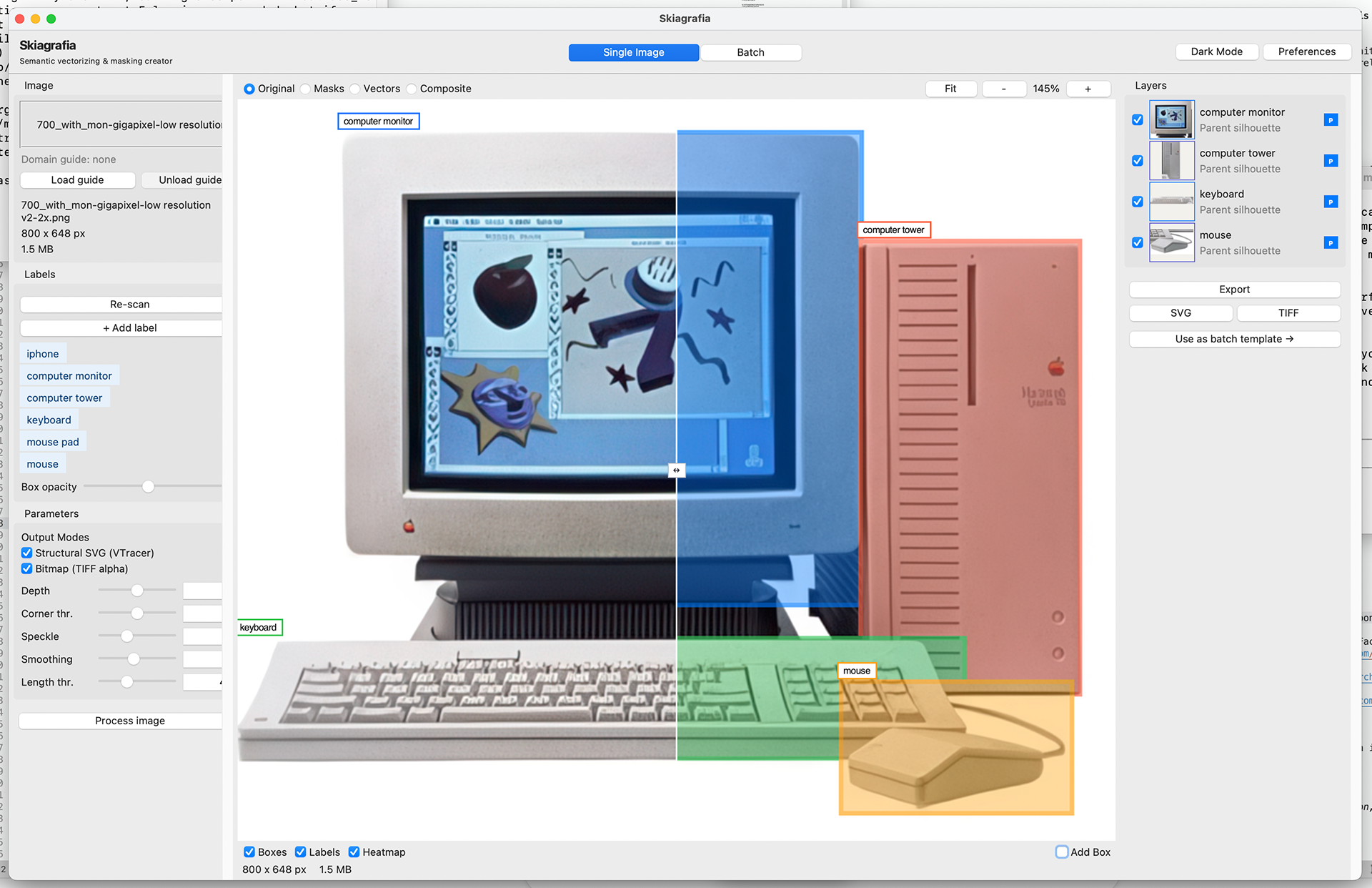 Full screenshot of Skiagrafia in Single Image mode on macOS. The title bar reads "Skiagrafia". A mode switcher at the top center shows "Single Image" selected in blue and "Batch" unselected. Top right has "Dark Mode" and "Preferences" buttons. The left sidebar shows the loaded image named "700_with_mon-gigapixel-low resolution v2-2x.png" at 800×648 pixels, 1.5 MB. Seven detected labels are listed in colored pills: iphone, computer monitor, computer tower, keyboard, mouse pad, mouse. Output Modes show Structural SVG (VTracer) and Bitmap (TIFF alpha) both checked. Parameter sliders for Depth, Corner thr., Speckle, Smoothing, and Length thr. are visible. A "Process image" button appears at the bottom of the sidebar. The main canvas shows a photograph of a vintage Macintosh computer setup at 145% zoom in Masks view. Four colored bounding boxes with labels are overlaid: a blue box labeled "computer monitor" around the CRT monitor, a red box labeled "computer tower" around the beige tower case, a green box labeled "keyboard" around the keyboard, and a gold box labeled "mouse" around the mouse. The right half of the canvas shows a blue segmentation mask already computed for the monitor region. The right panel shows a Layers list with four entries — computer monitor, computer tower, keyboard, mouse — each labeled "Parent silhouette" with a blue P badge and a small thumbnail. Below the layers, Export buttons for SVG and TIFF are visible, along with a "Use as batch template →" button. At the bottom of the canvas, checkboxes for Boxes, Labels, and Heatmap are all checked.