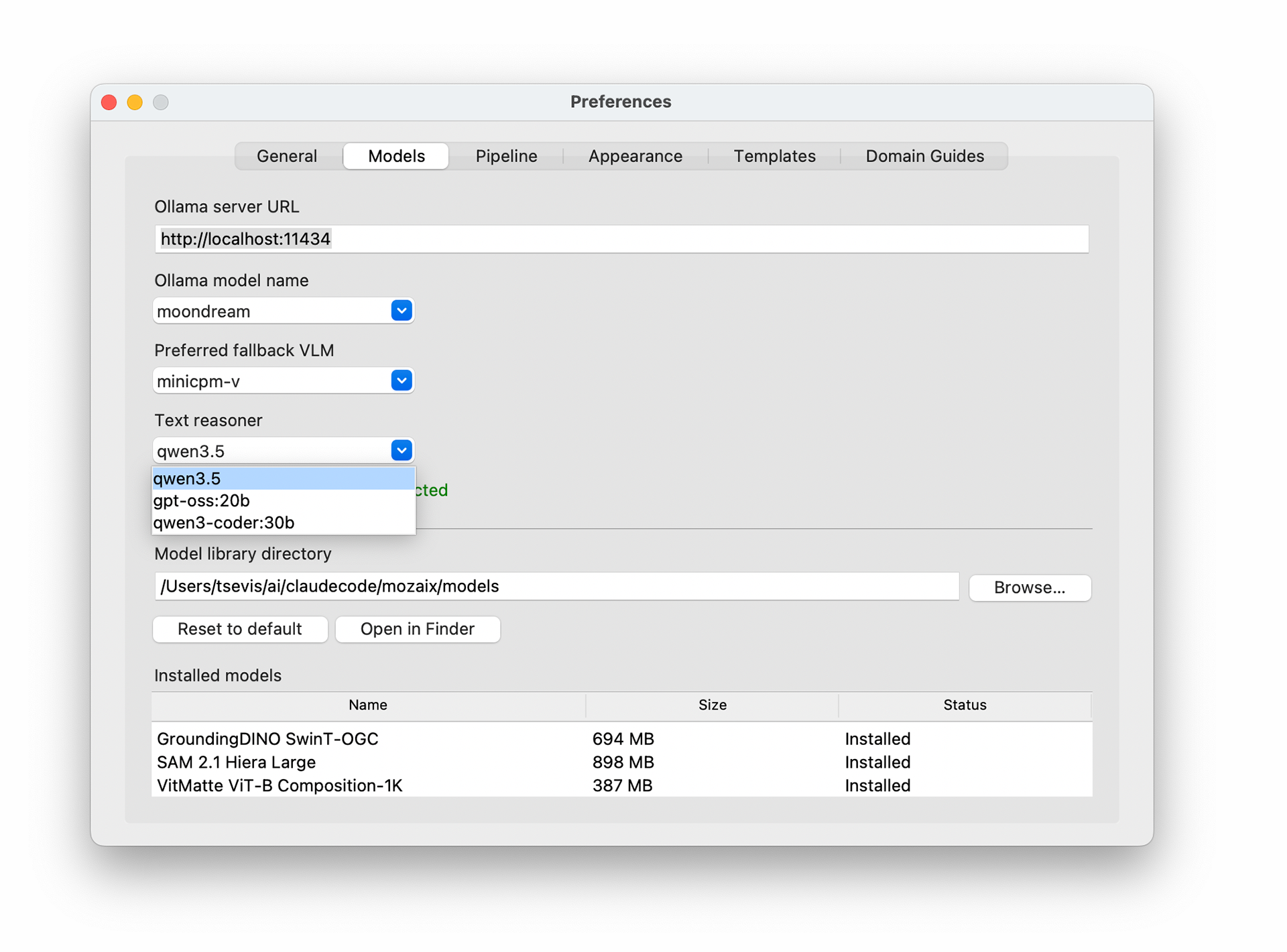 Screenshot of the Skiagrafia Preferences window, Models tab selected. Fields show Ollama server URL set to http://localhost:11434, Ollama model name set to moondream, preferred fallback VLM set to minicpm-v, and text reasoner set to qwen3.5 with a dropdown open showing three options: qwen3.5 (highlighted), gpt-oss:20b, and qwen3-coder:30b. The model library directory is set to /Users/tsevis/ai/claudecode/mozaix/models. Below, a table lists three installed models: GroundingDINO SwinT-OGC at 694 MB, SAM 2.1 Hiera Large at 898 MB, and VitMatte ViT-B Composition-1K at 387 MB, all with status Installed.