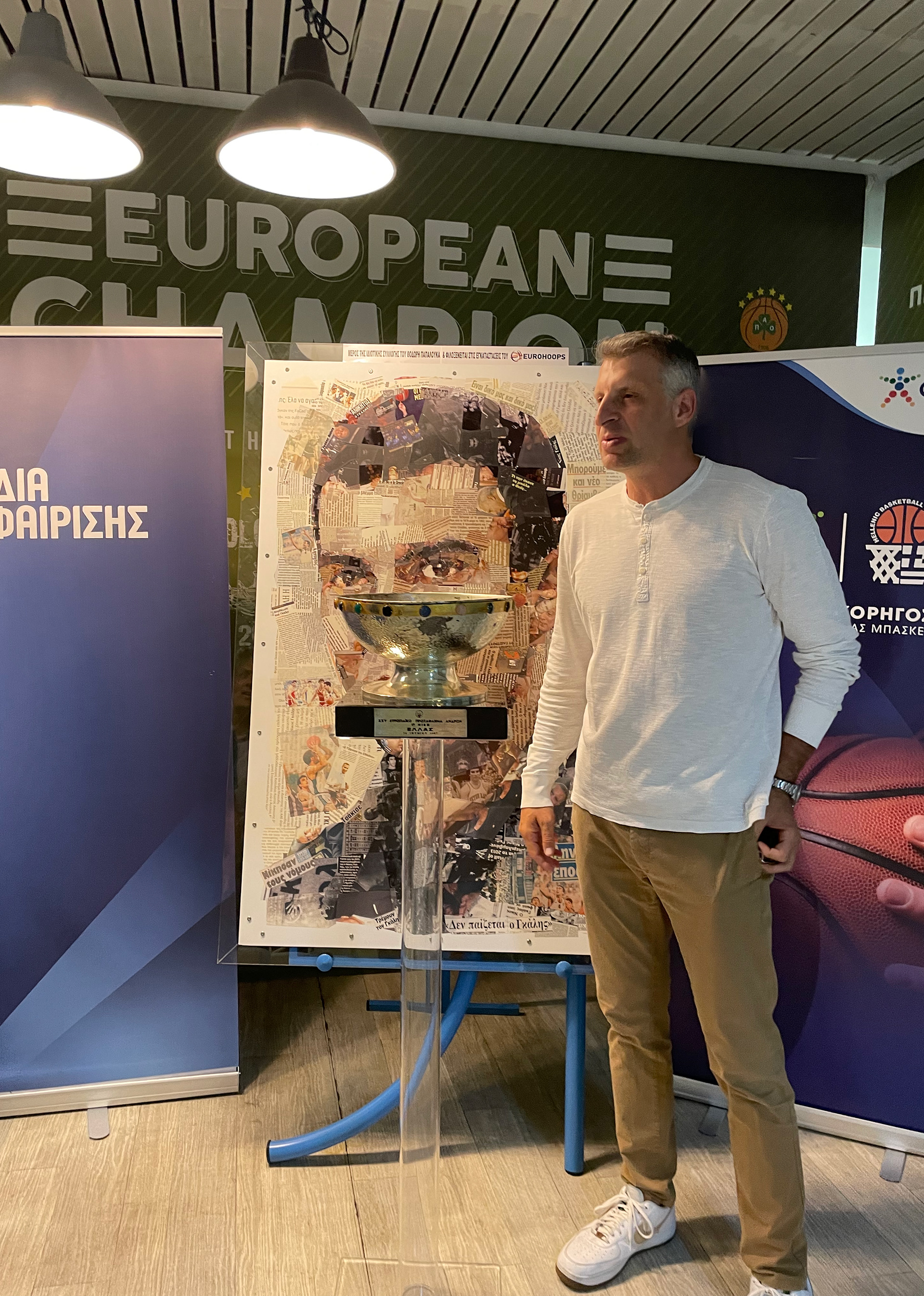 Theodoros Papaloukas with Galis' portrait and a trophy of 1987