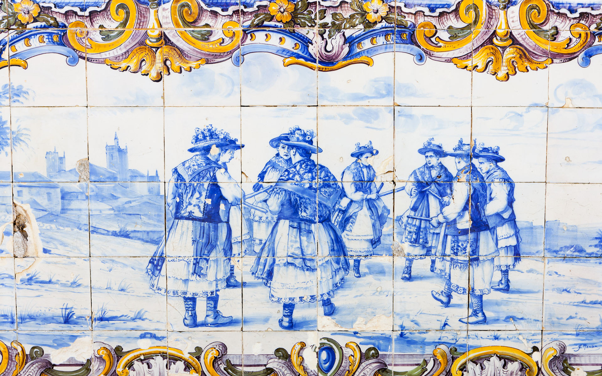 Traditional blue-and-white Azulejo tile mural at Pinhão railway station depicting men loading barrels of port wine onto boats in the Douro Valley.