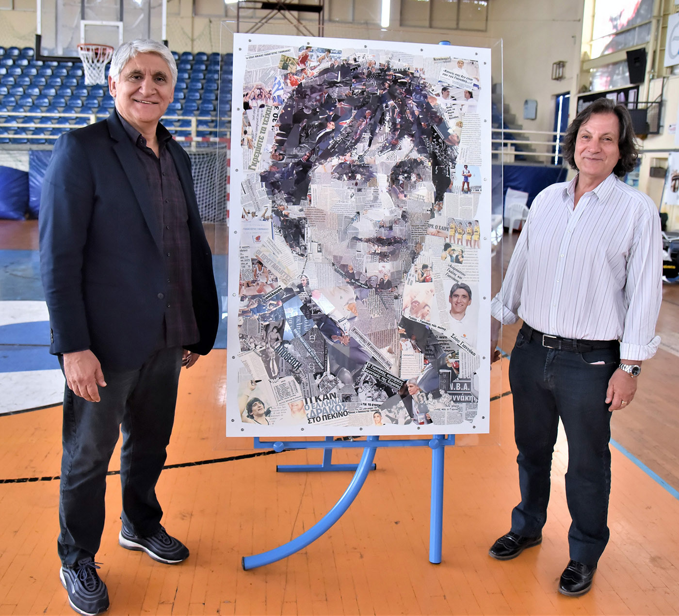 Legendary Greek basketball player and coach Panagiotis Giannakis, alongside Takis Kaloudis, President of the Hellenic Wheelchair Basketball Federation, pose with a mosaic portrait of Giannakis.
