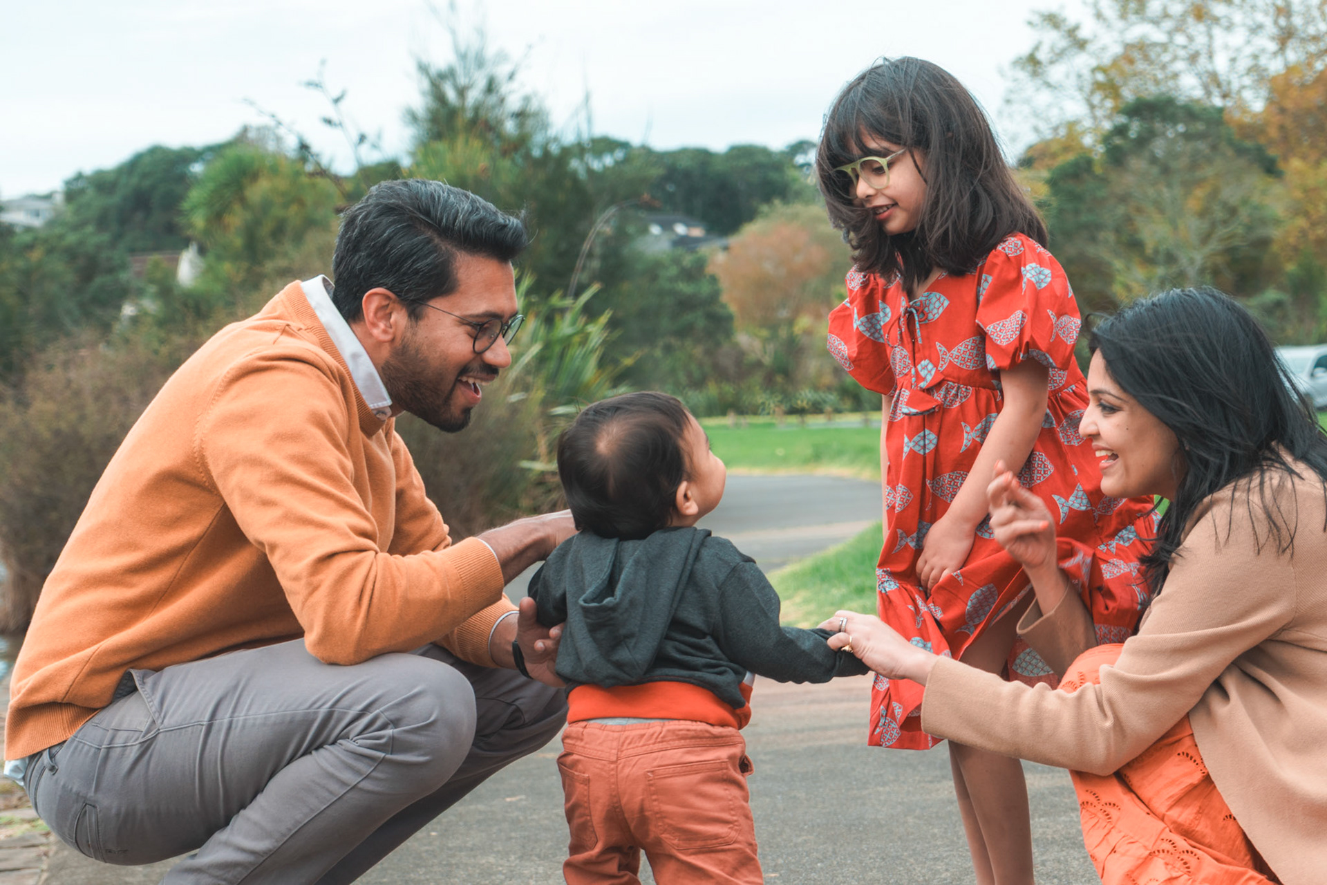 Candid family moment in Auckland park, with a baby.