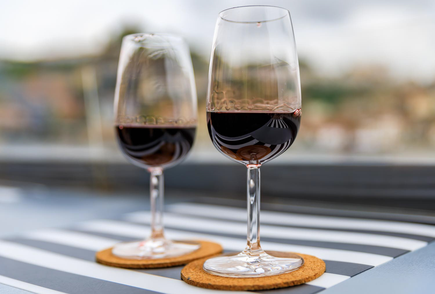 Glass of port wine with the blurred cityscape of Porto Portugal in the background