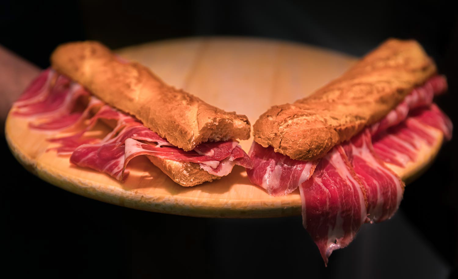 Serrano iberico ham sandwiches on a platter at a local shop in Pamplona Spain