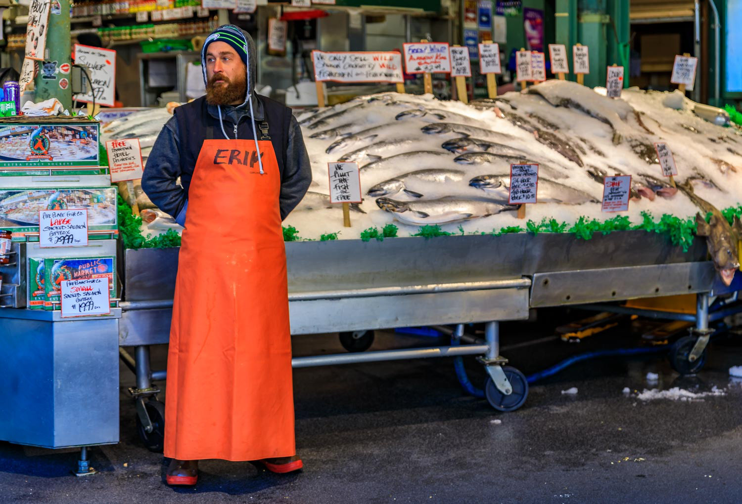 Fishmonger at a stall with fresh salmon for sale at Pike Place Market  Seattle