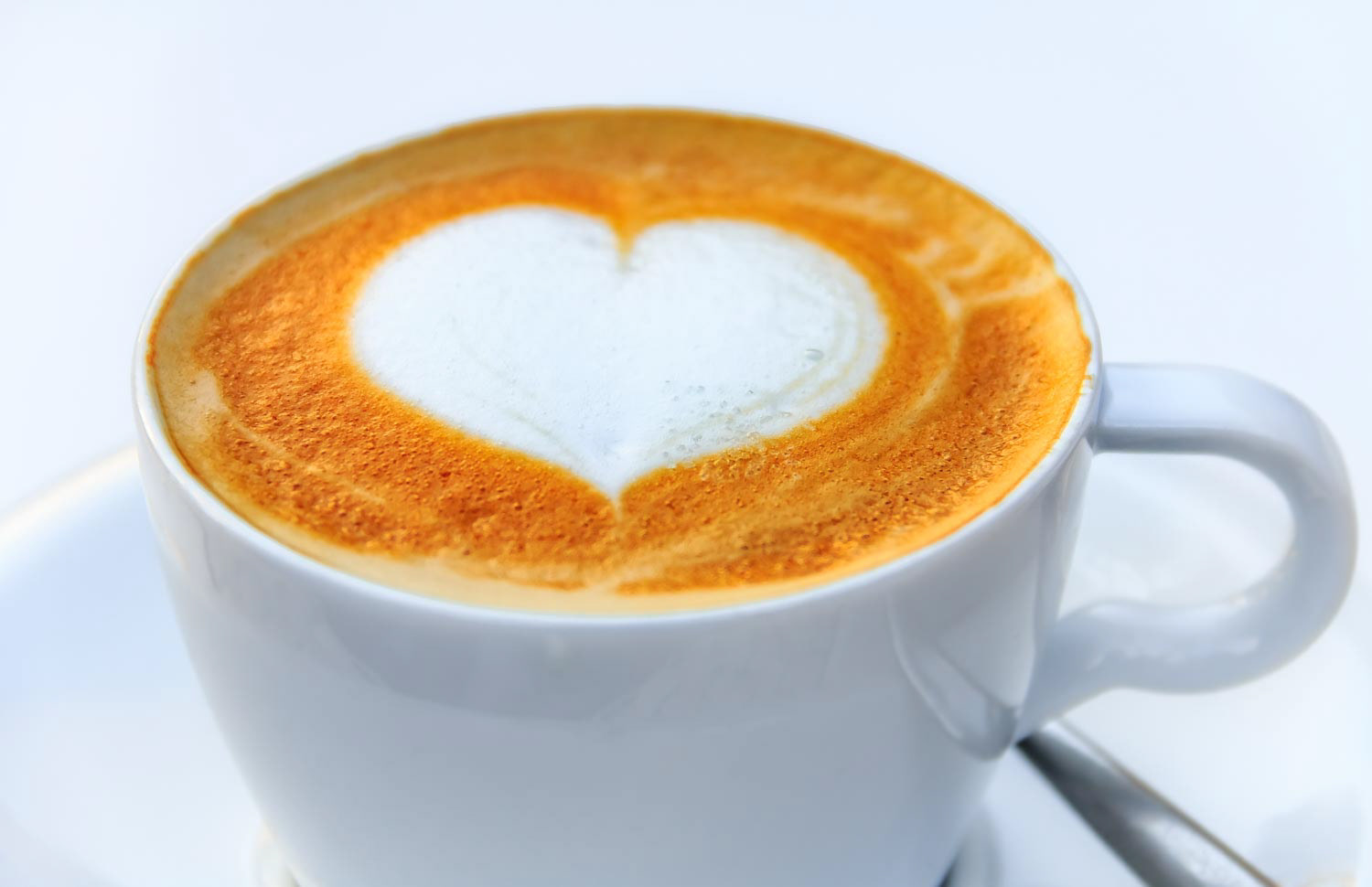 Cup of coffee with a latte art heart design at a cafe in Palma de Mallorca in Spain