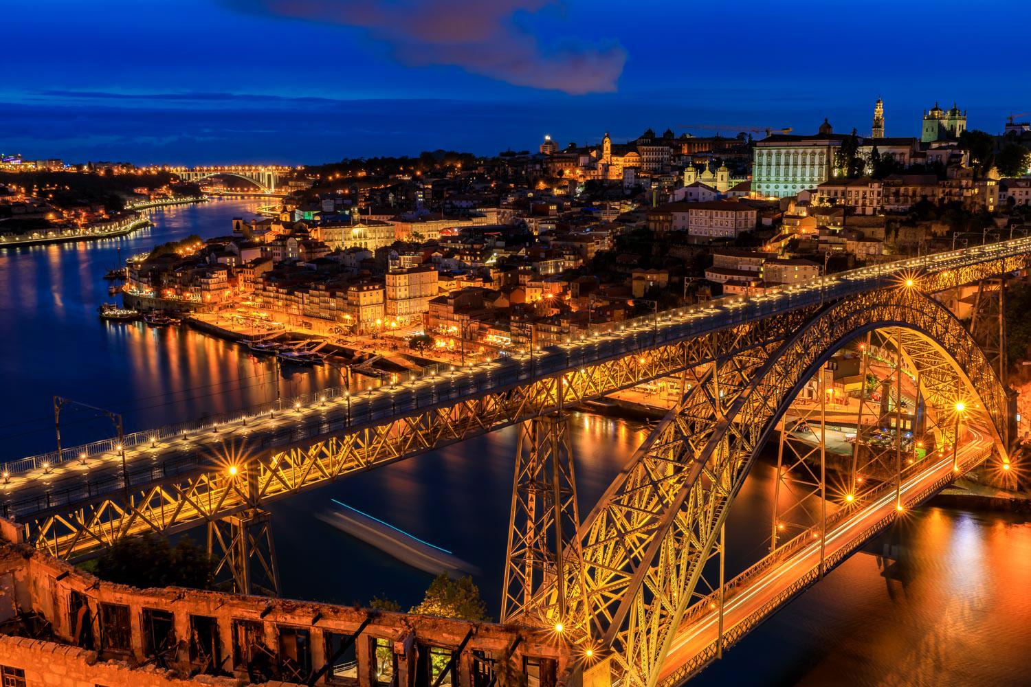 Sunset view of Porto Portugal cityscape with Dom Luis I Bridge and Douro River