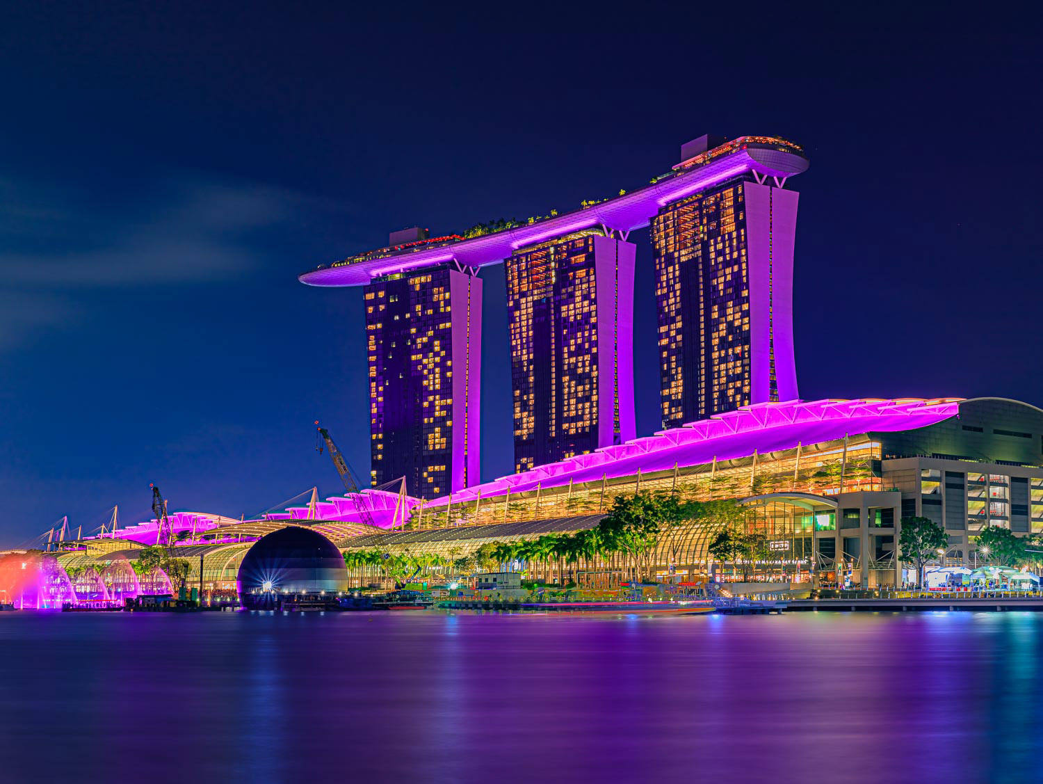 View of the illuminated famous luxury hotel, shopping center and casino Marina Bay Sands after sunset Singapore