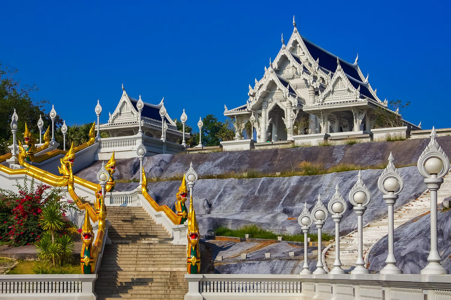 The staircase decorated with ornate naga statues and the Thai Buddhist temple of Wat Kaew Korawaram in Krabi, Thailand
