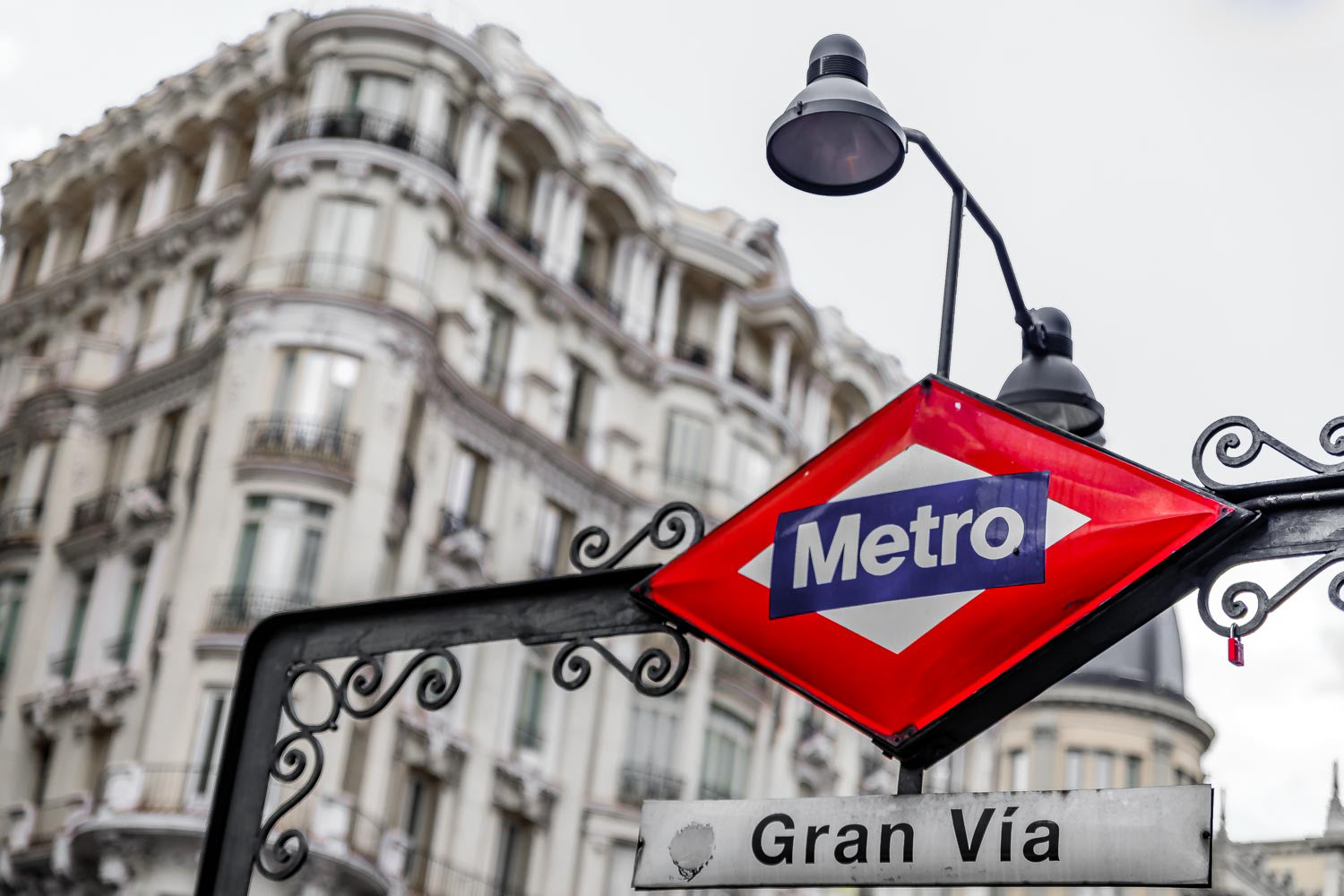 Traditional metro sign for the Gran Via station in city center shopping area, selective color treatment in Madrid, Spain