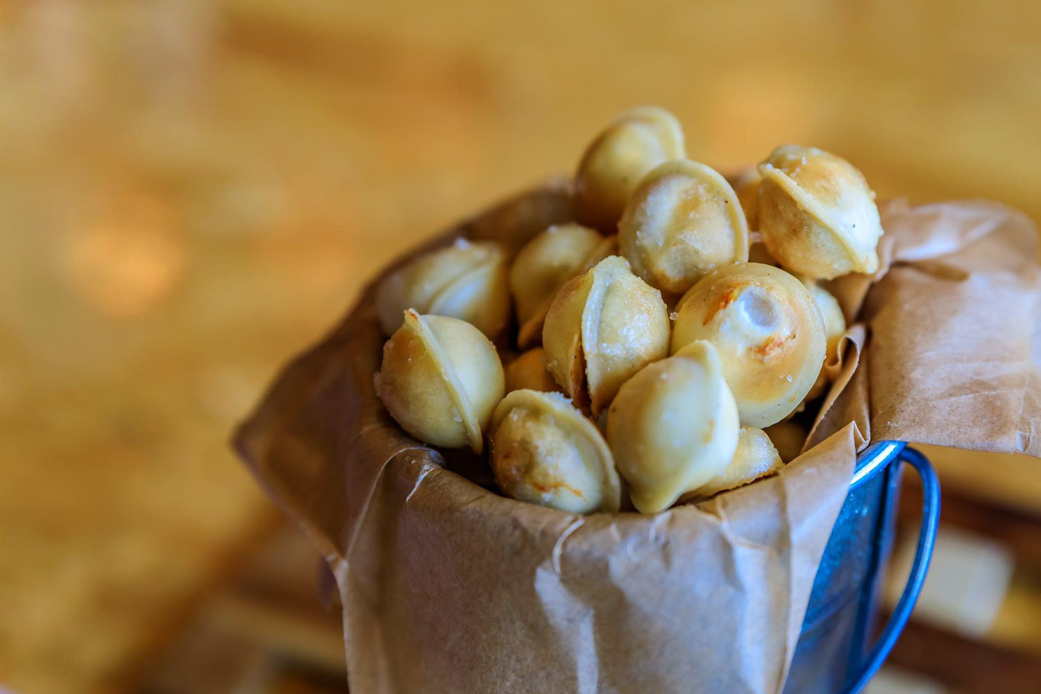 Traditional Russian fried pelmeni dumplings, stuffed with ground meat served in a tin bucket in a restaurant in Russia