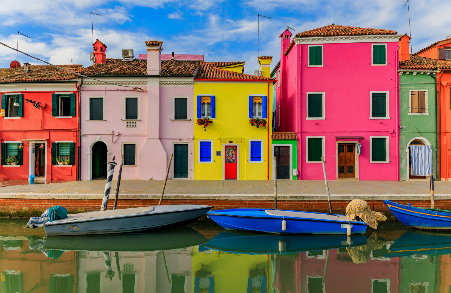Picturesque and colorful houses on the main street of Burano island near Venice Italy