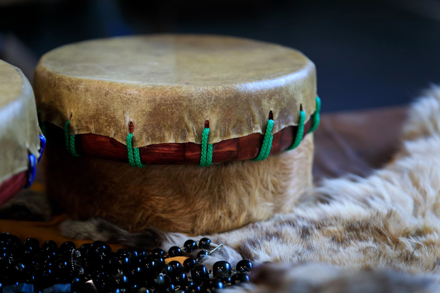Hand-made Native American shaman drum made of buffalo hide with beads and fur