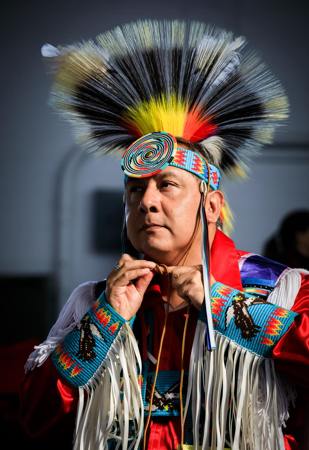 Native American Indian in intricate and colorful traditional outfit at a powwow in San Francisco, USA