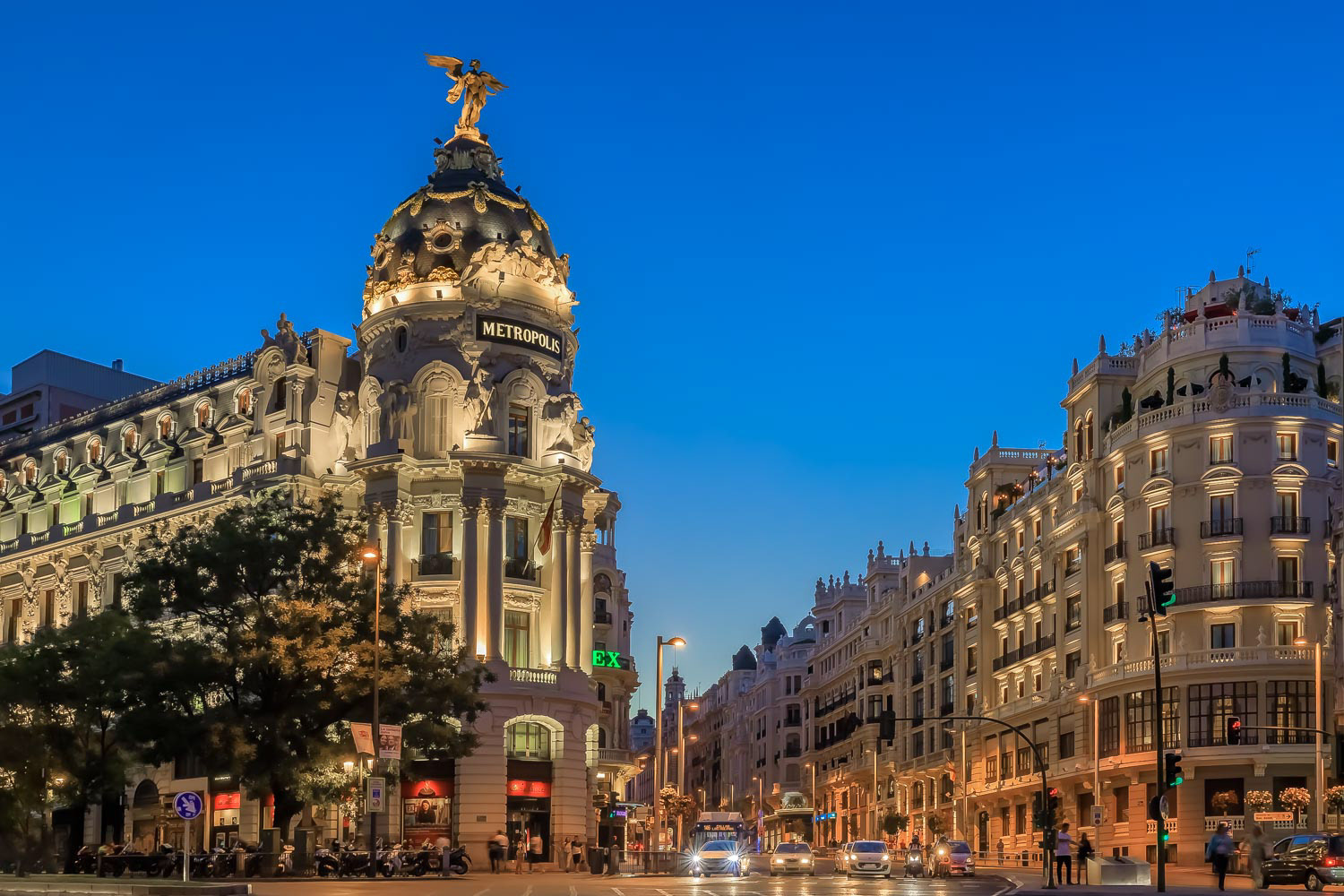 Sunset view of Metropolis, one of the most beautiful buildings in Madrid Spain and Gran Via, main shopping street 